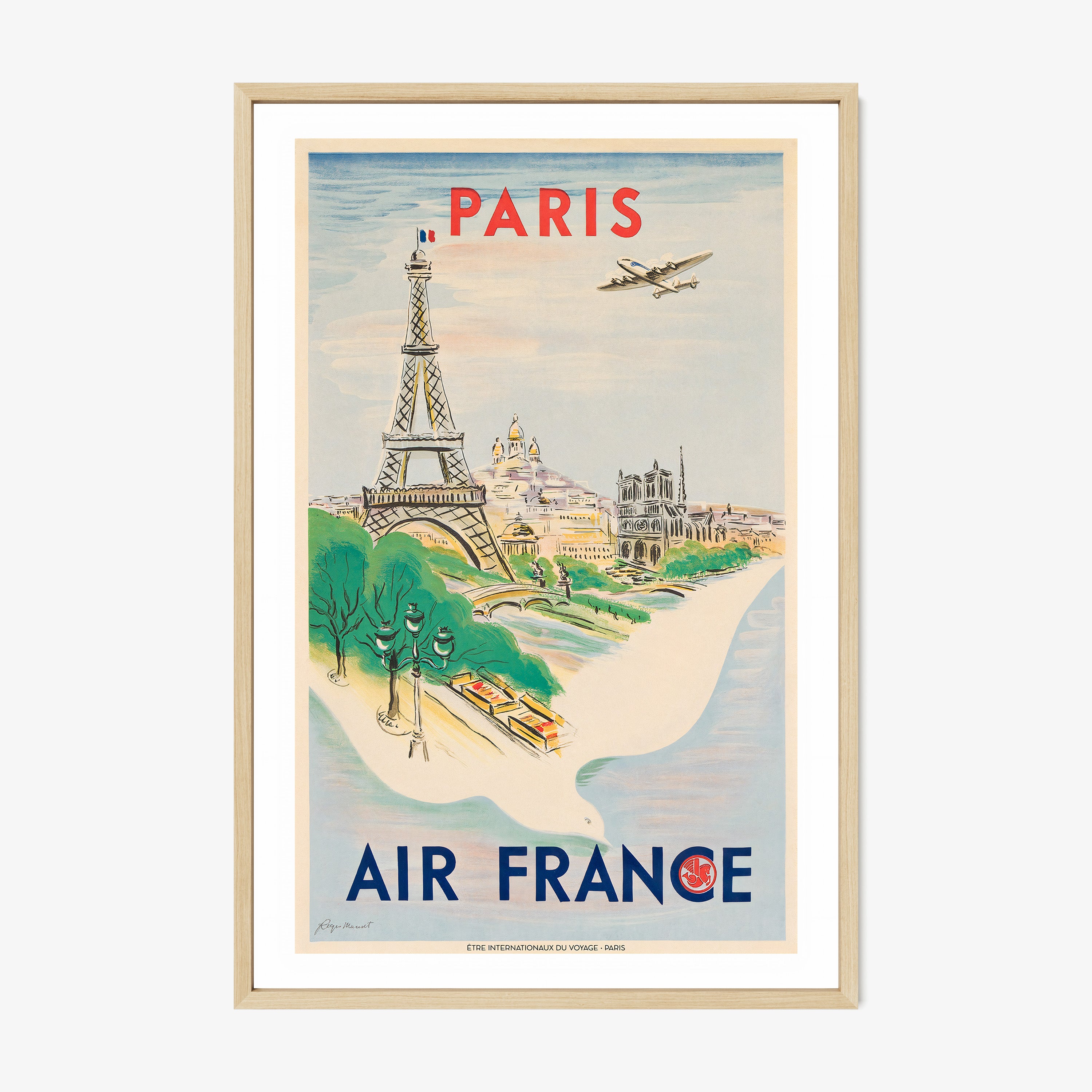 Framed Air France poster of Paris on a wall