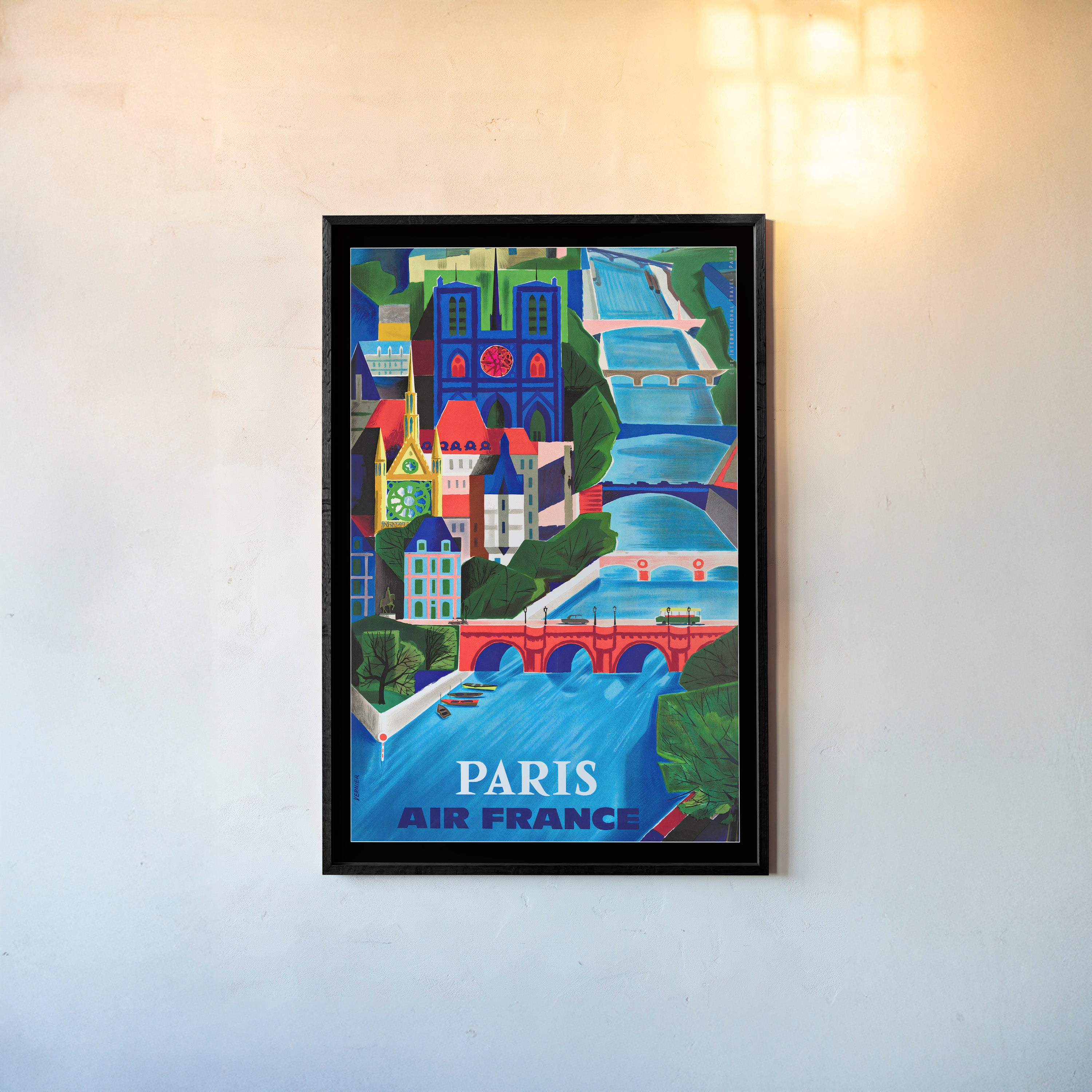 Framed poster of Paris featuring a colorful blue river with many bridges hanging on a light background