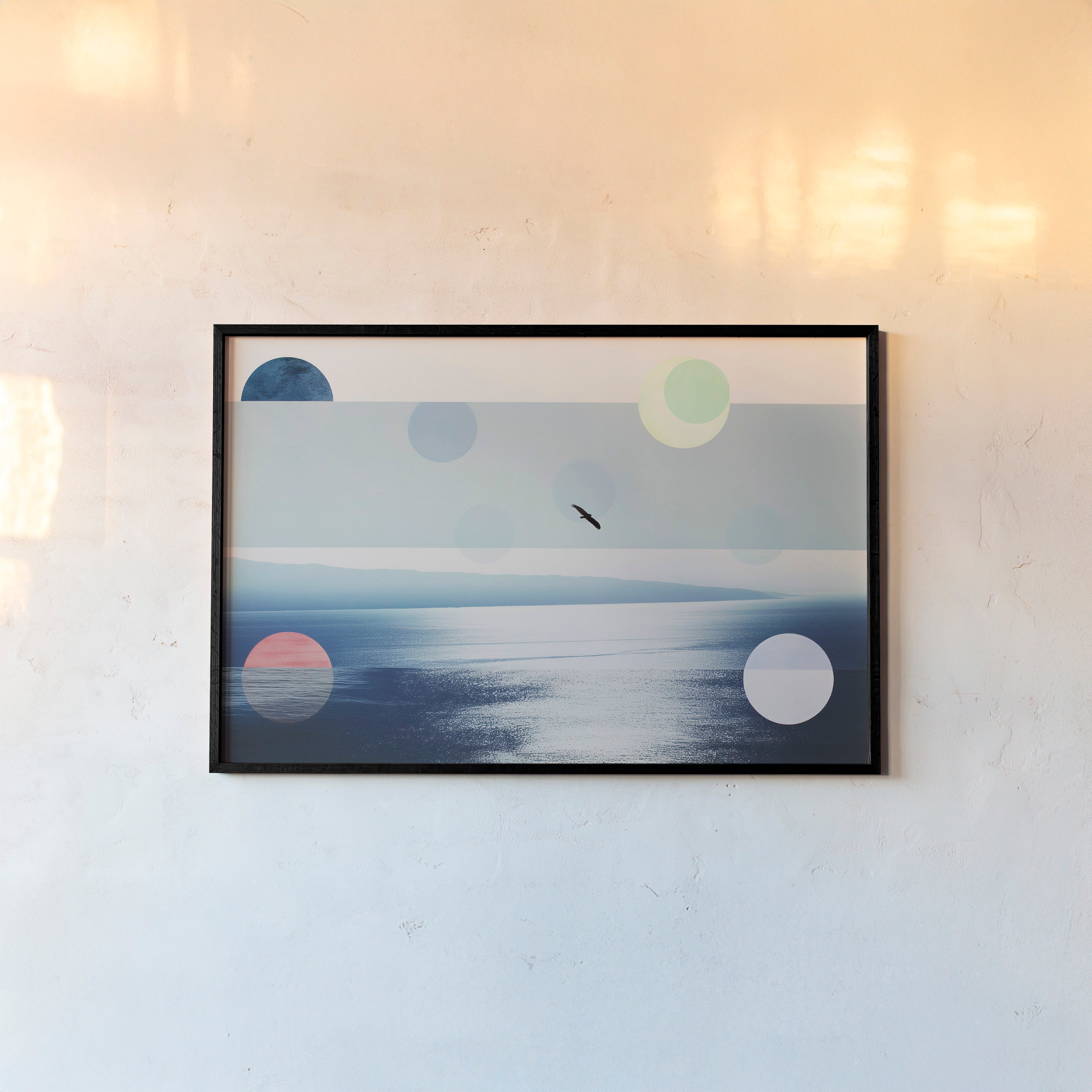Framed poster featuring an ocean scene with a bird flying hanging on a light background