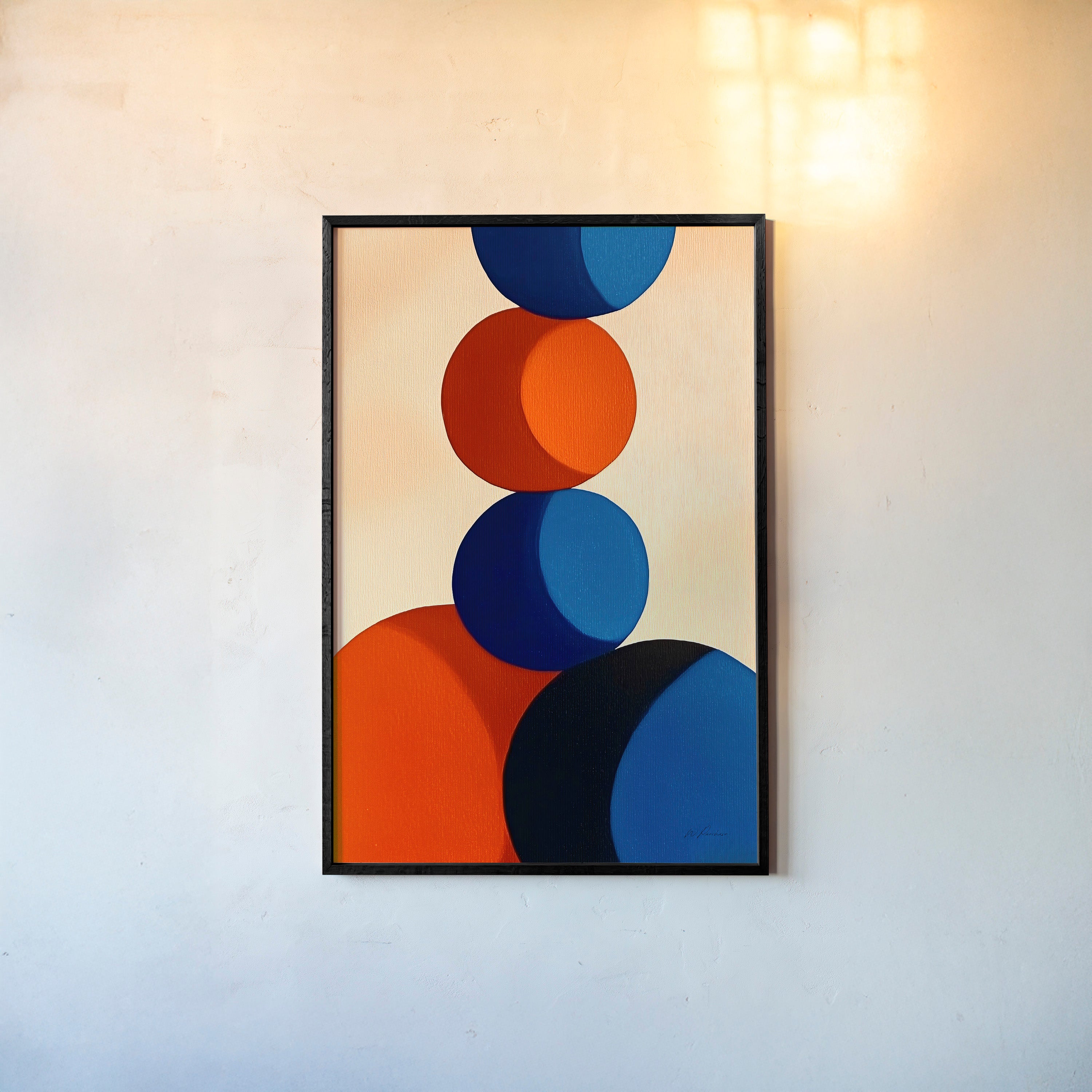 Framed poster of red and blue circle stacked on each other hanging on a light background