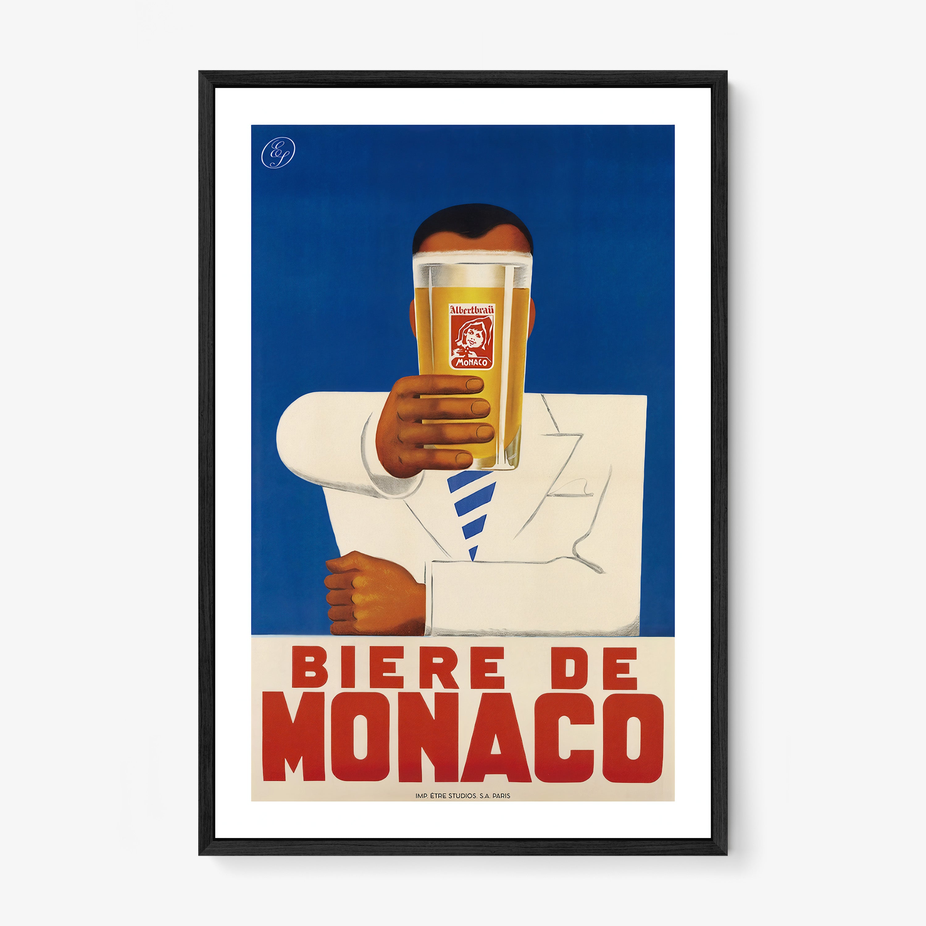 A framed poster features a person holding a beer with bold text "Biere De Monaco"