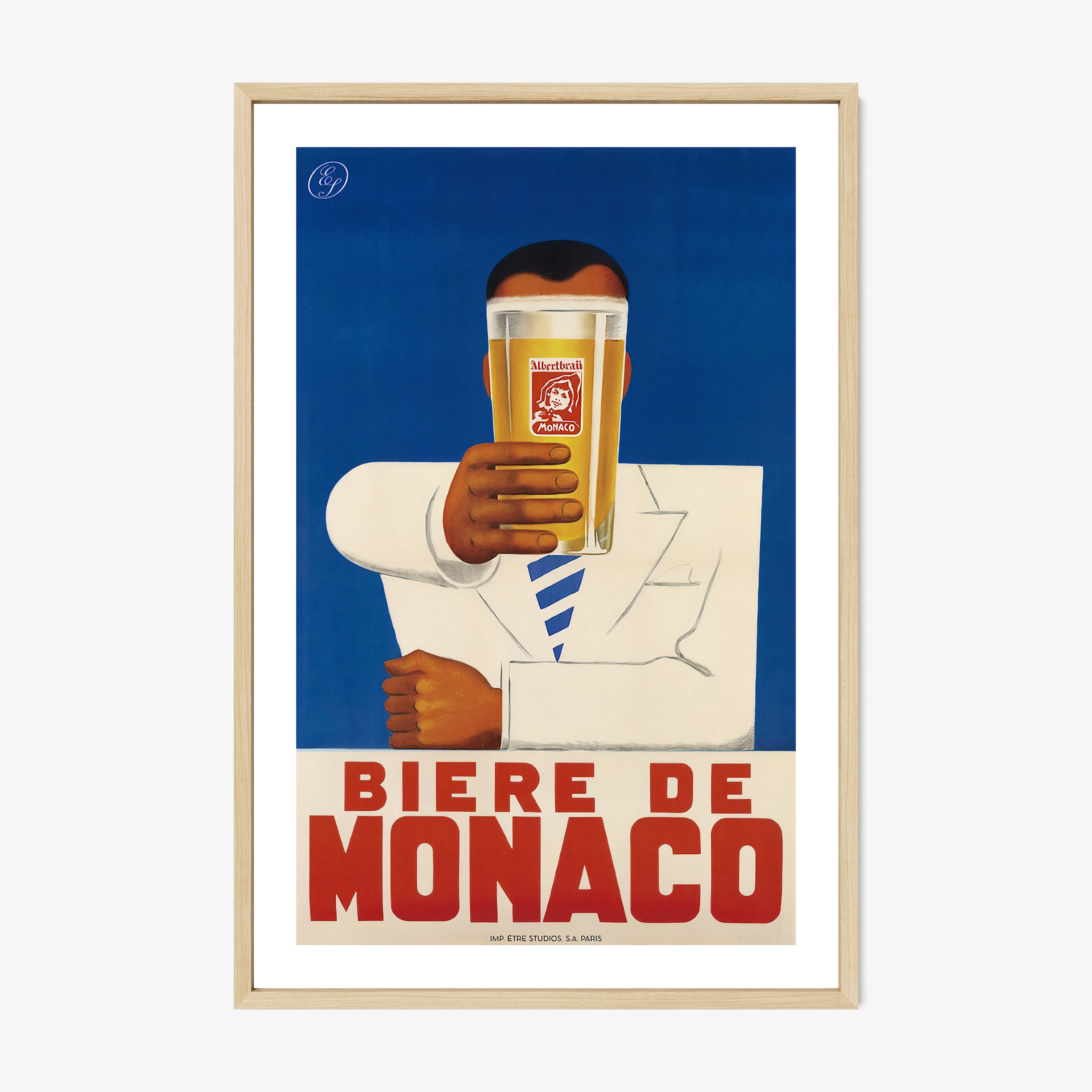 A framed poster features a person holding a beer with bold text "Biere De Monaco"