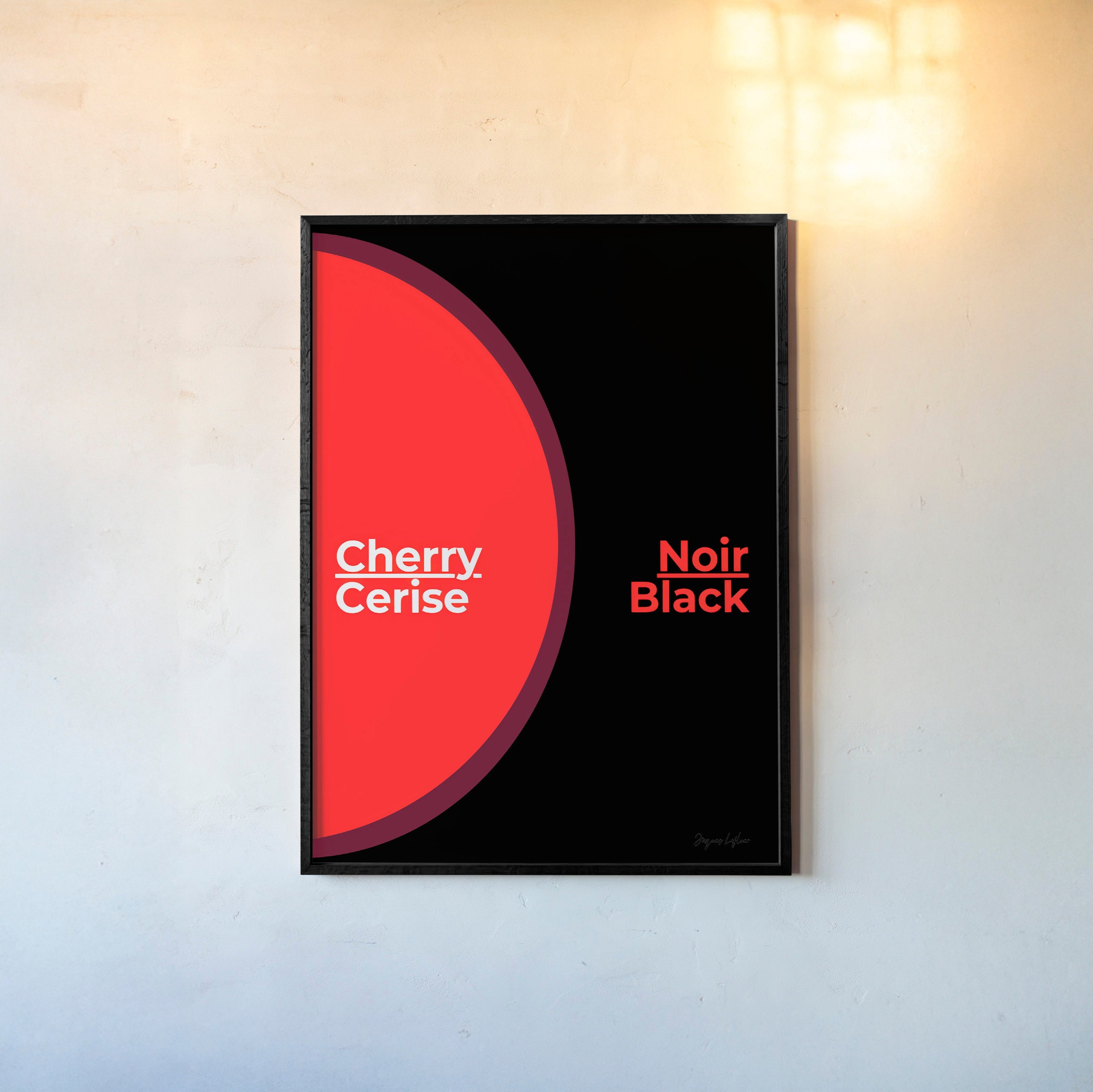 Framed poster of the words "Cherry Black" in English and French hanging on a light background