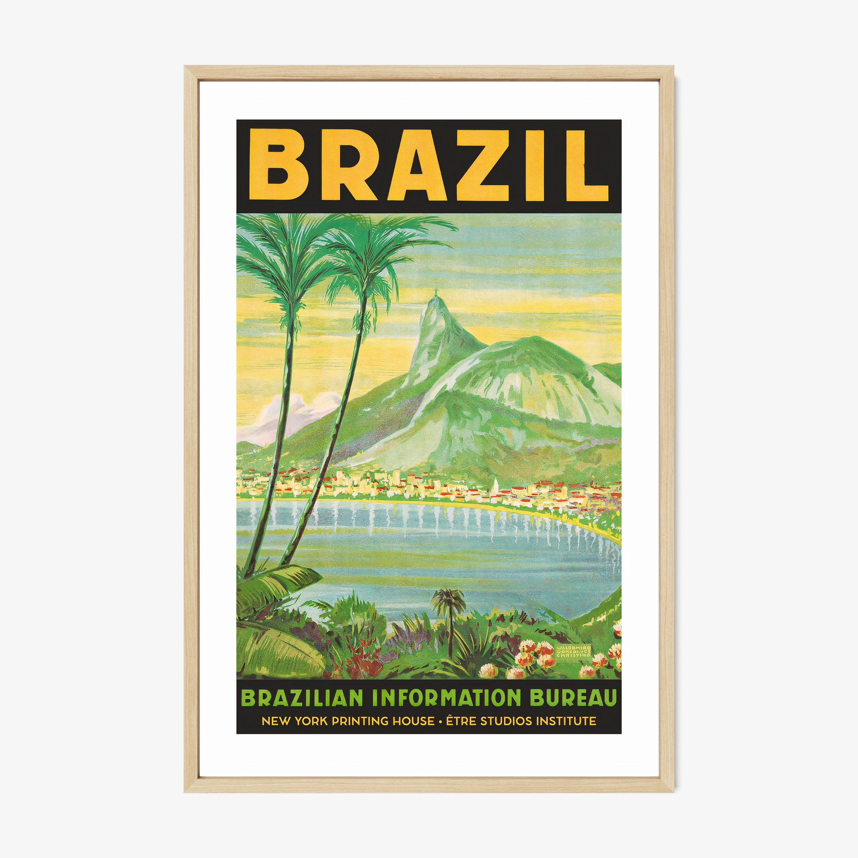 Framed poster of a waterfront with mountains in the background and the words "Brazil" in large letters at the top sitting on a light background