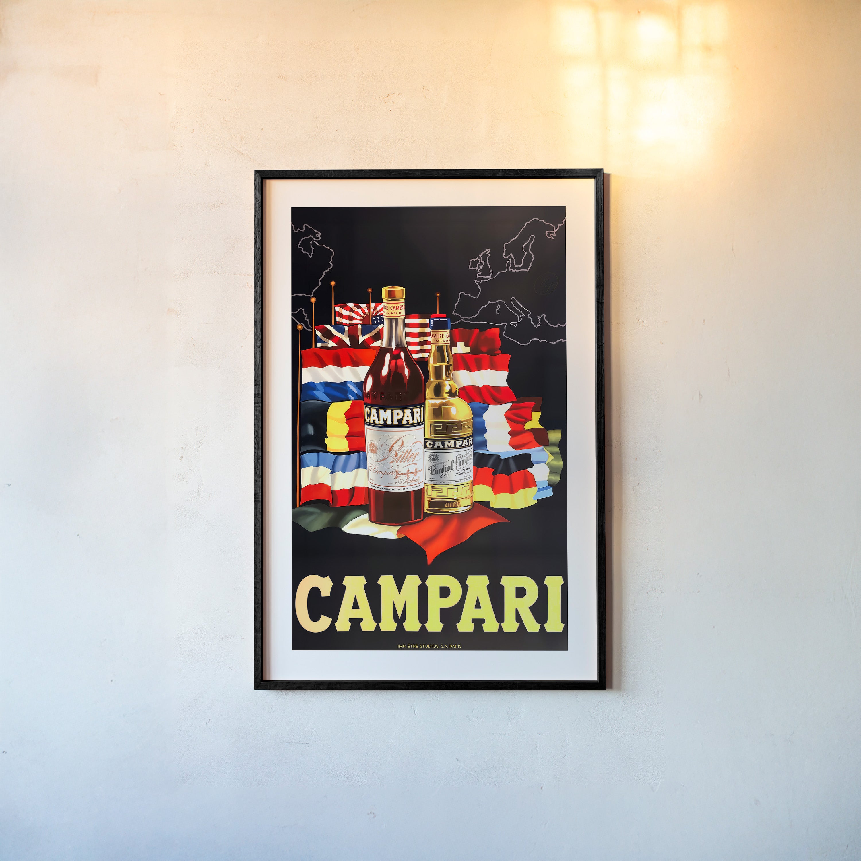 A framed poster features "Campari" bottles with various international flags in the background