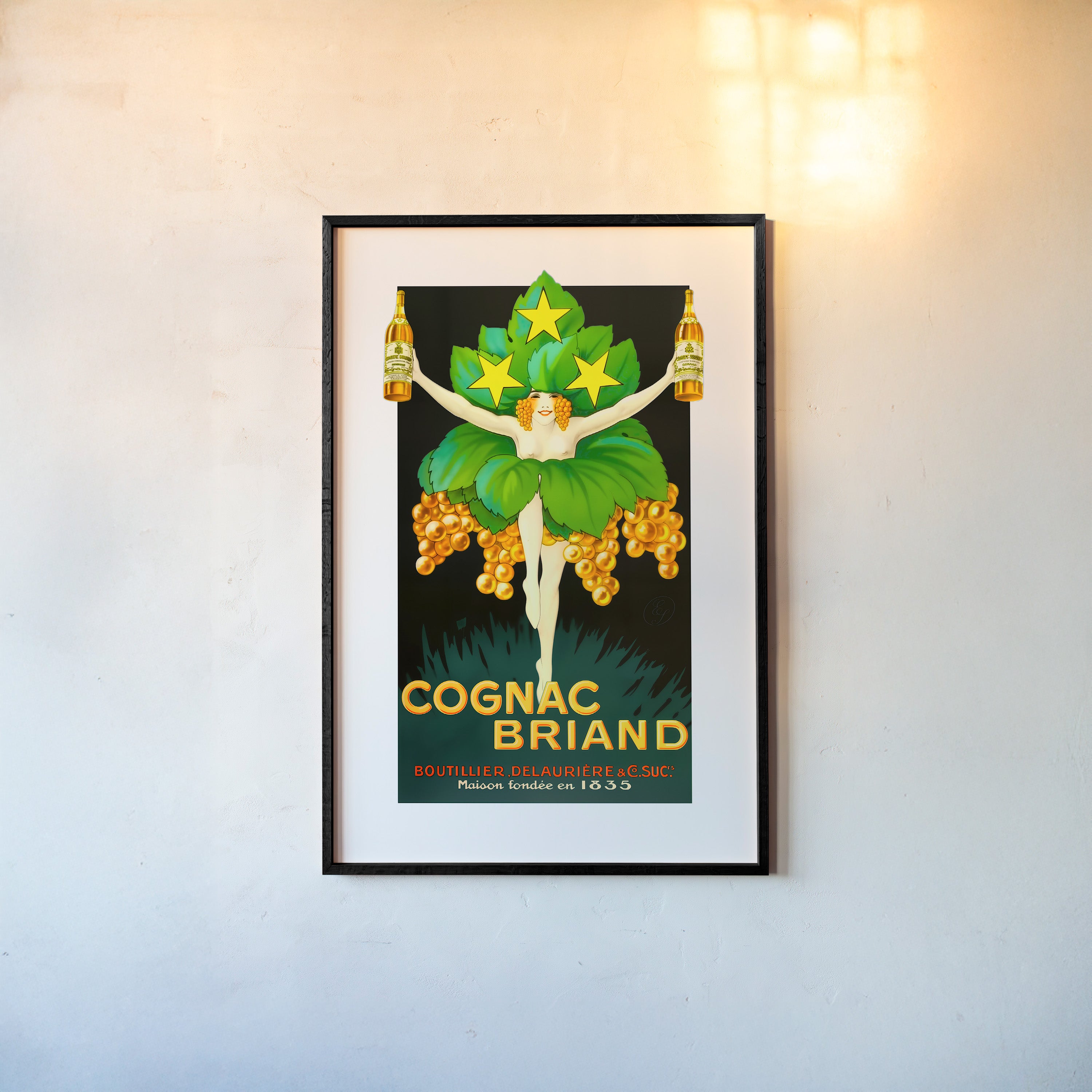 A framed poster features a dressed up woman centered over the words "Cognac Briand"