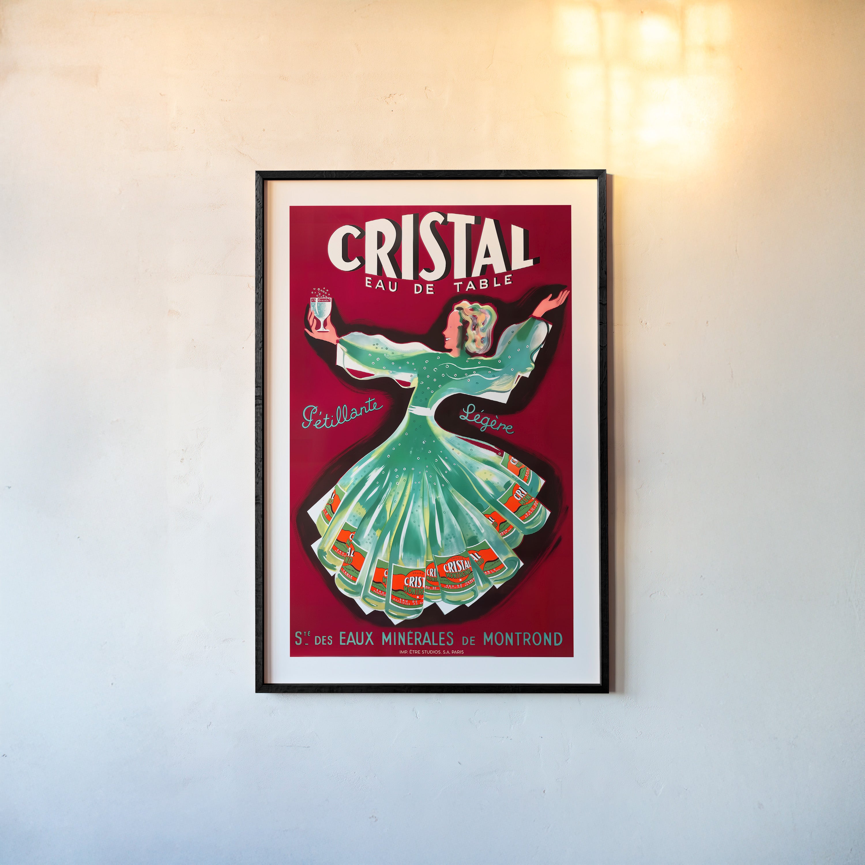 A framed poster features a whimsical woman dancing holding a glass of Cristal