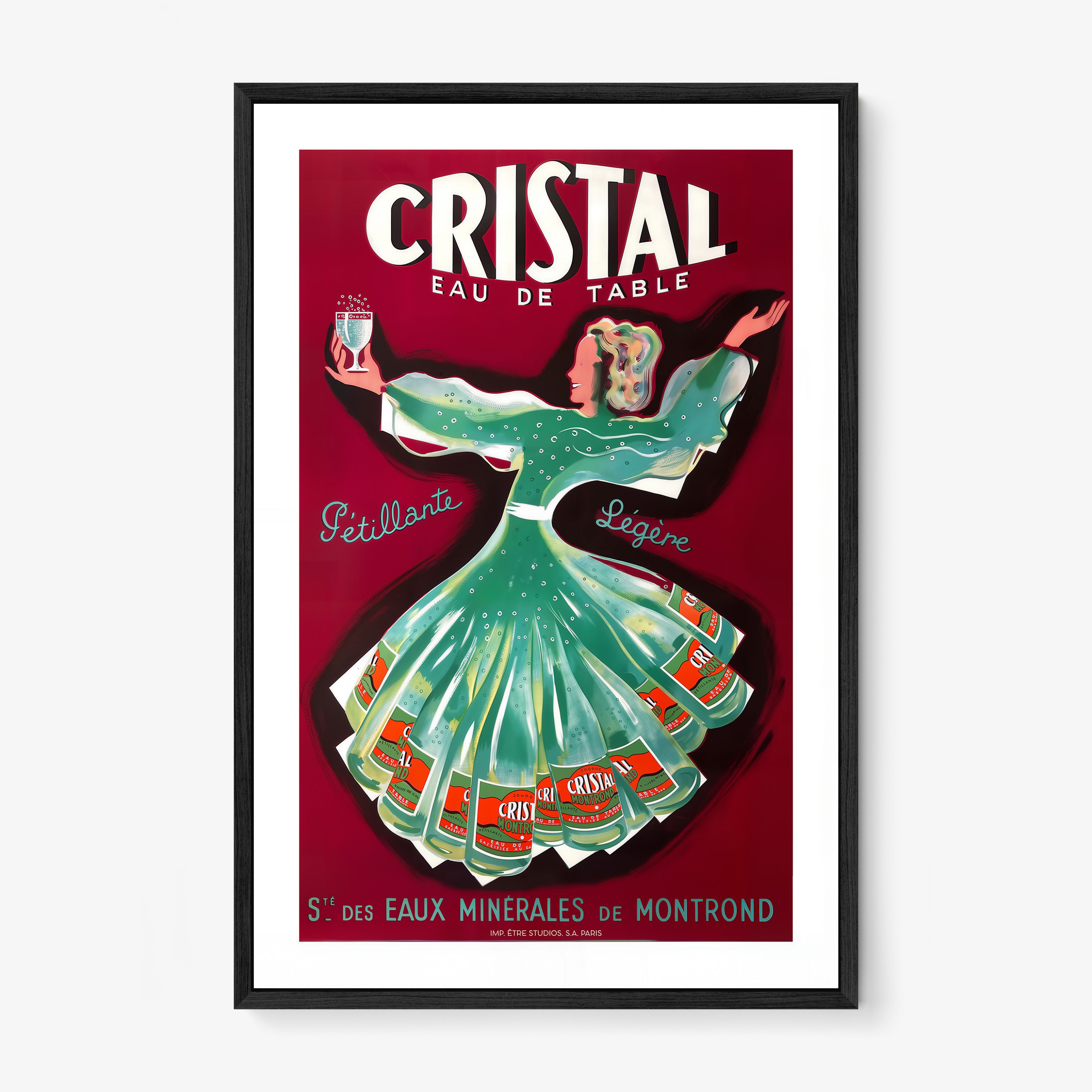A framed poster features a whimsical woman dancing holding a glass of cristal