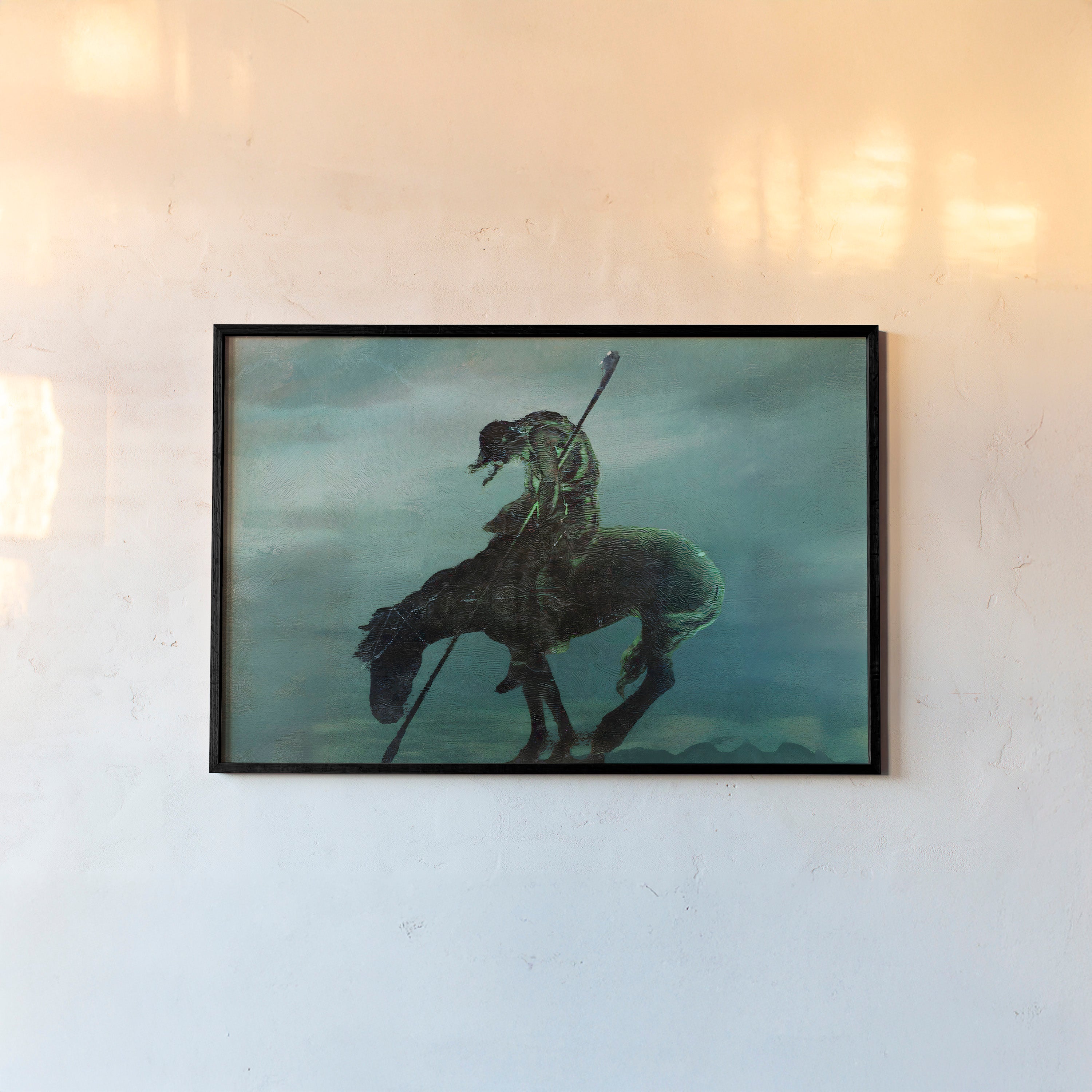Framed poster of a horseman in a dark setting hanging on a light background