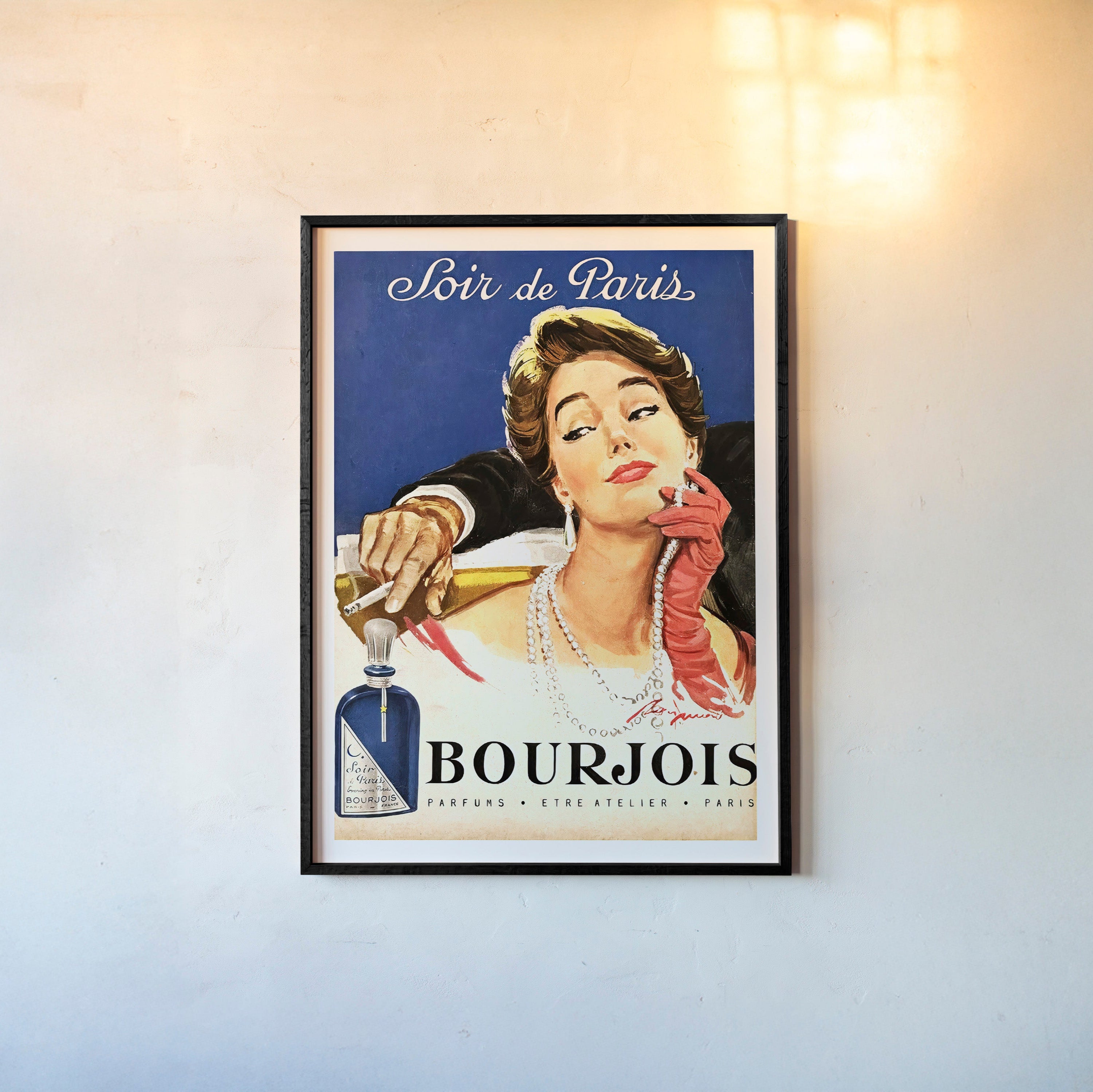 Framed image of an elegant woman with the text "Soir de Paris" at the top hanging on a light background