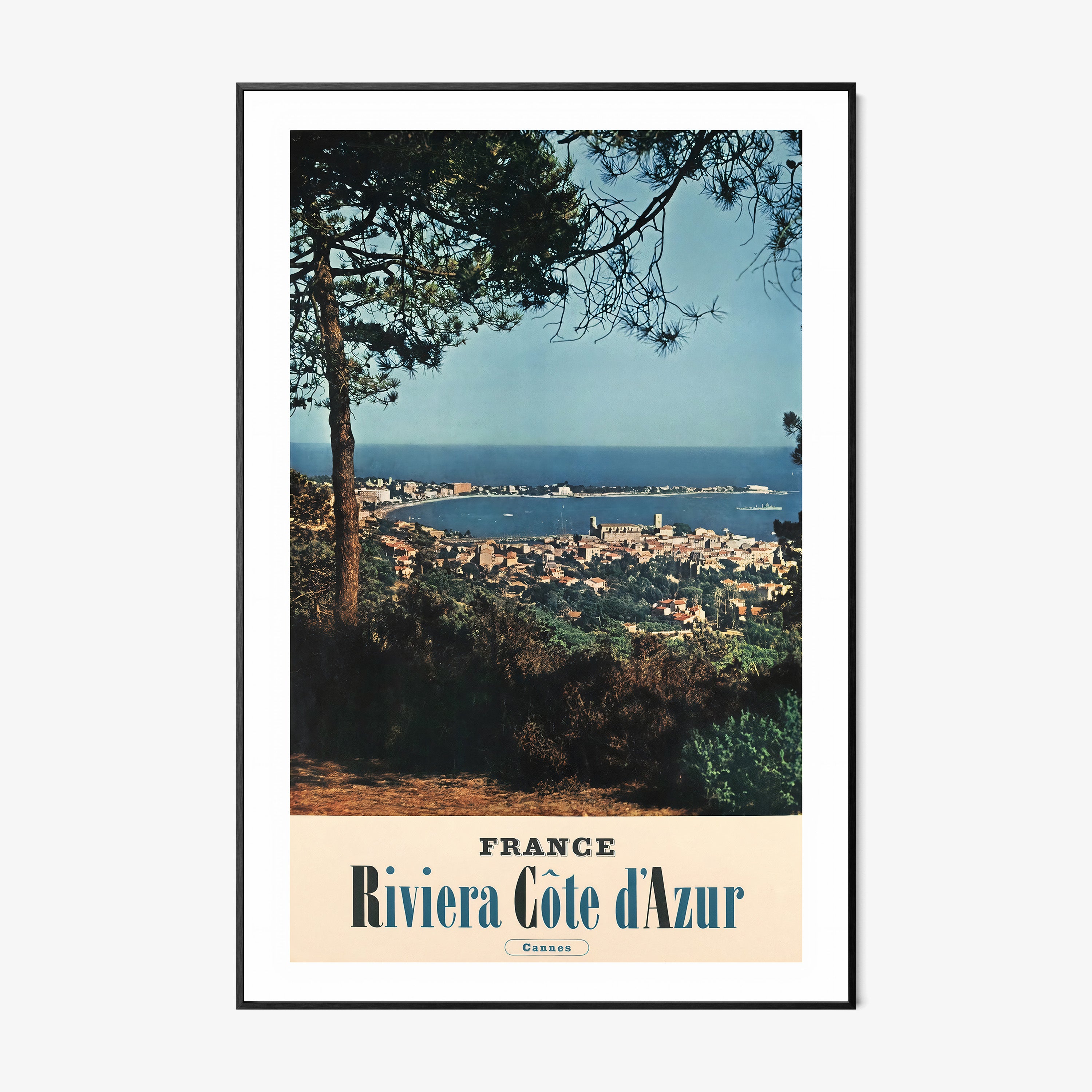 Poster of an ocean and city viewpoint with the text "France Riviera Cote d'Azur" on the bottom hanging on a light background