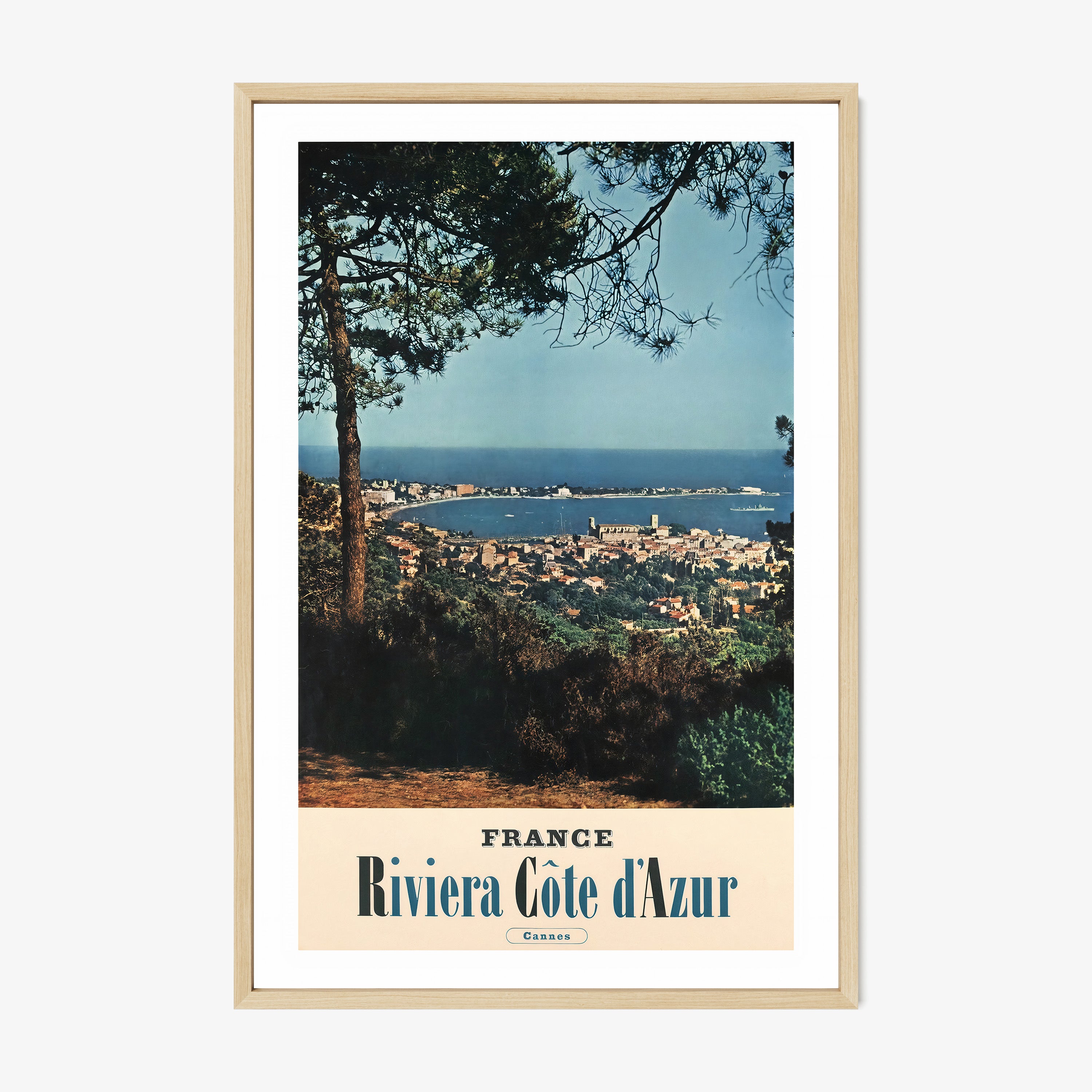 Poster of an ocean and city viewpoint with the text "France Riviera Cote d'Azur" on the bottom hanging on a light background