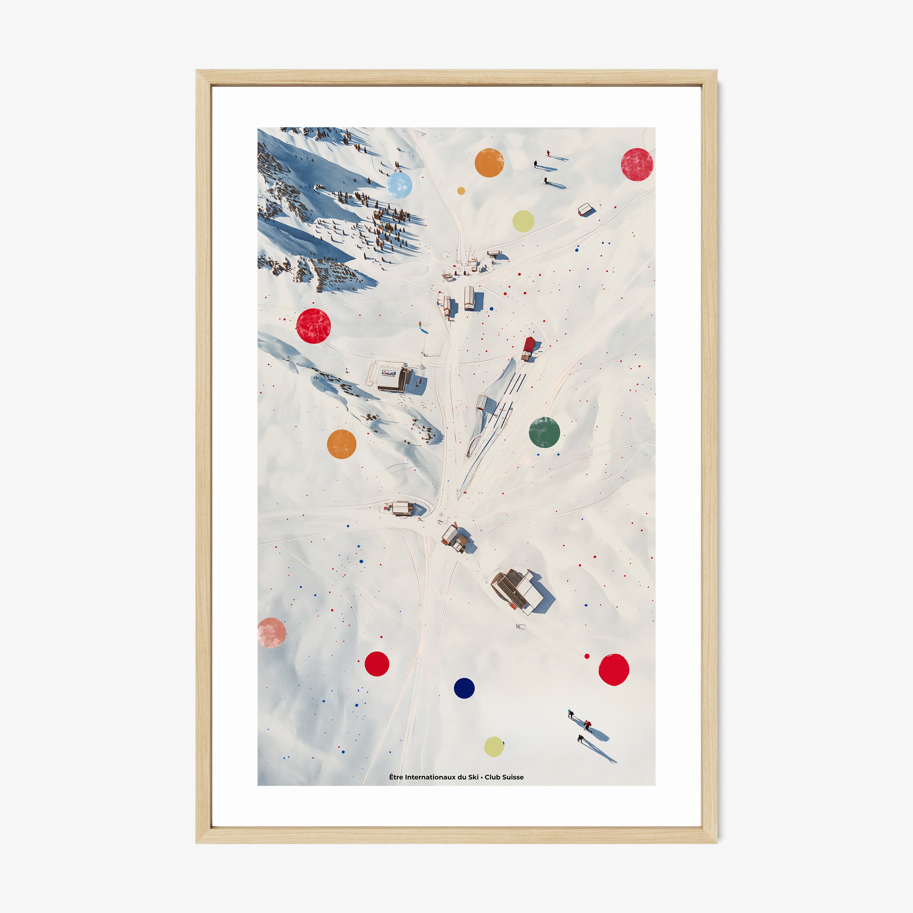 Framed poster of an overhead view of a snowy covered ski area hanging on a light background