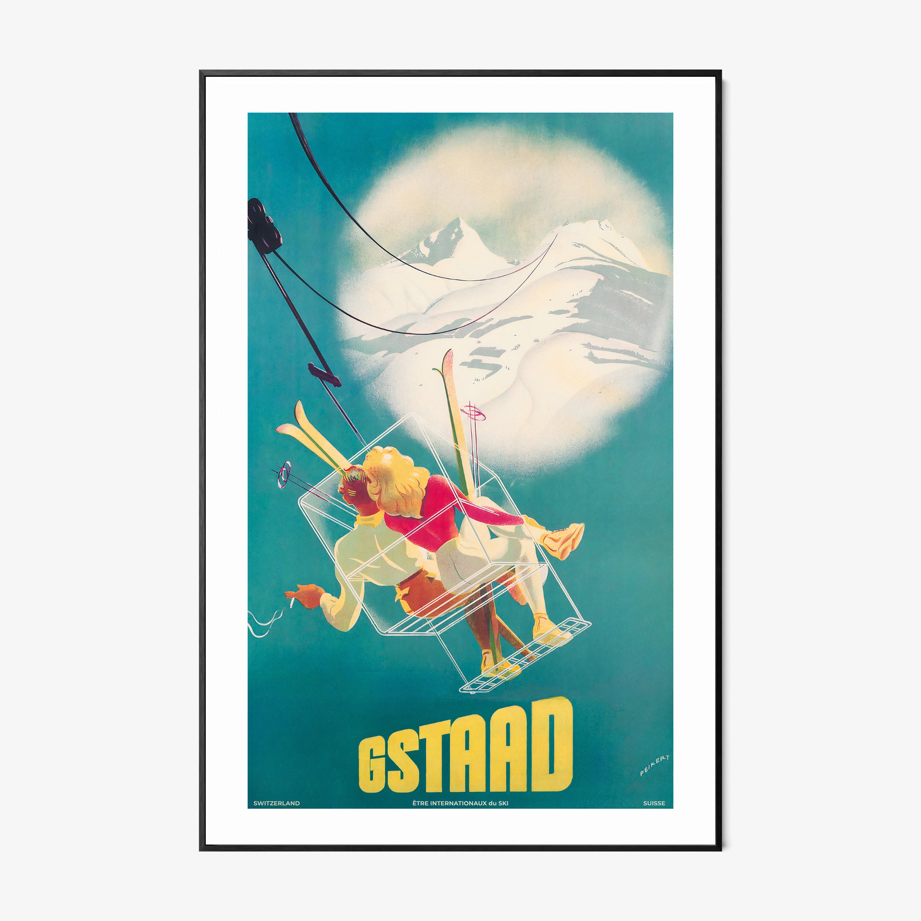 Framed poster of a whimsical ski lift image featuring two people and the text "GSTAAD" at the bottom hanging with a light background