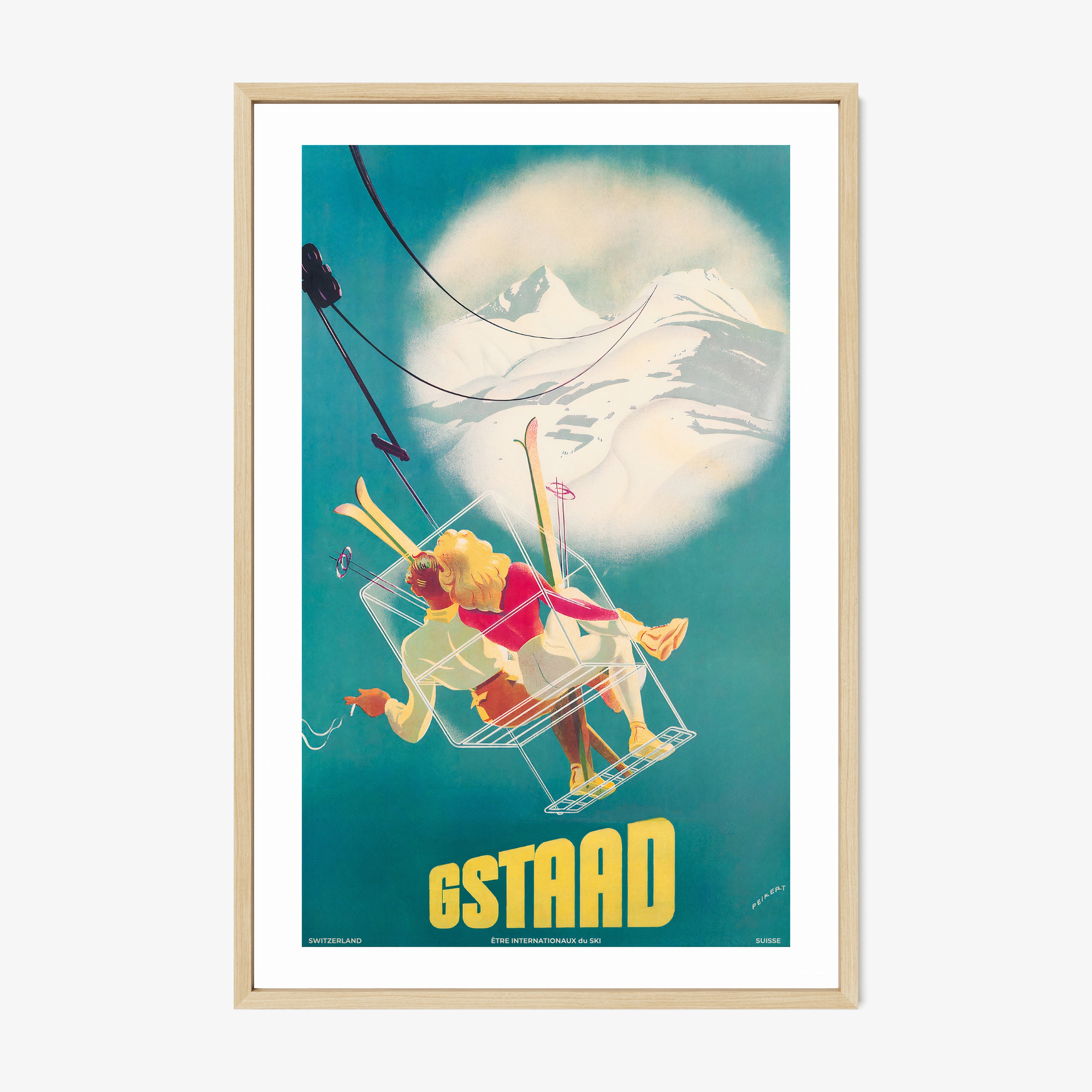 Framed poster of a whimsical ski lift image featuring two people and the text "GSTAAD" at the bottom hanging with a light background