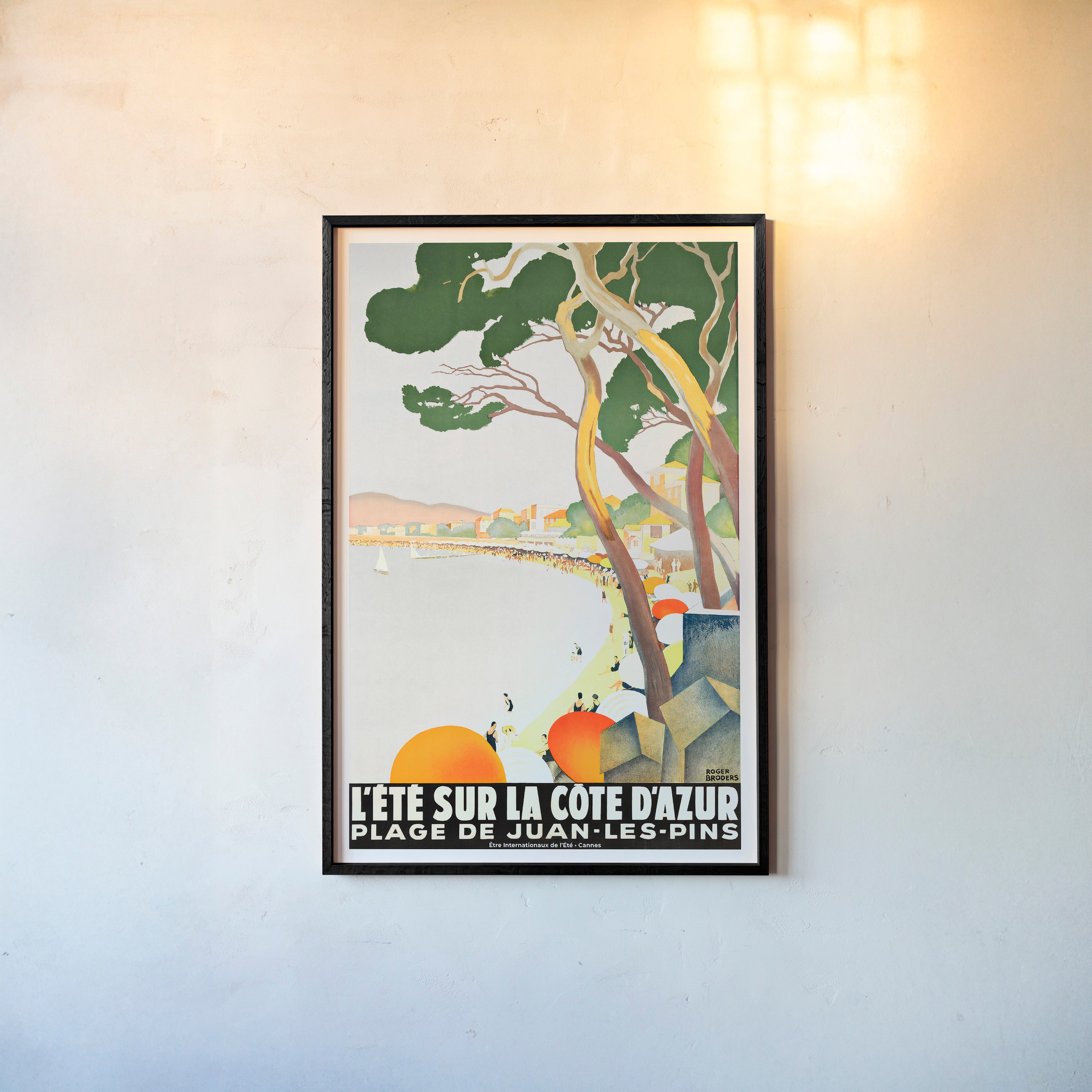 Framed poster of a coastal beach area hanging on a light background