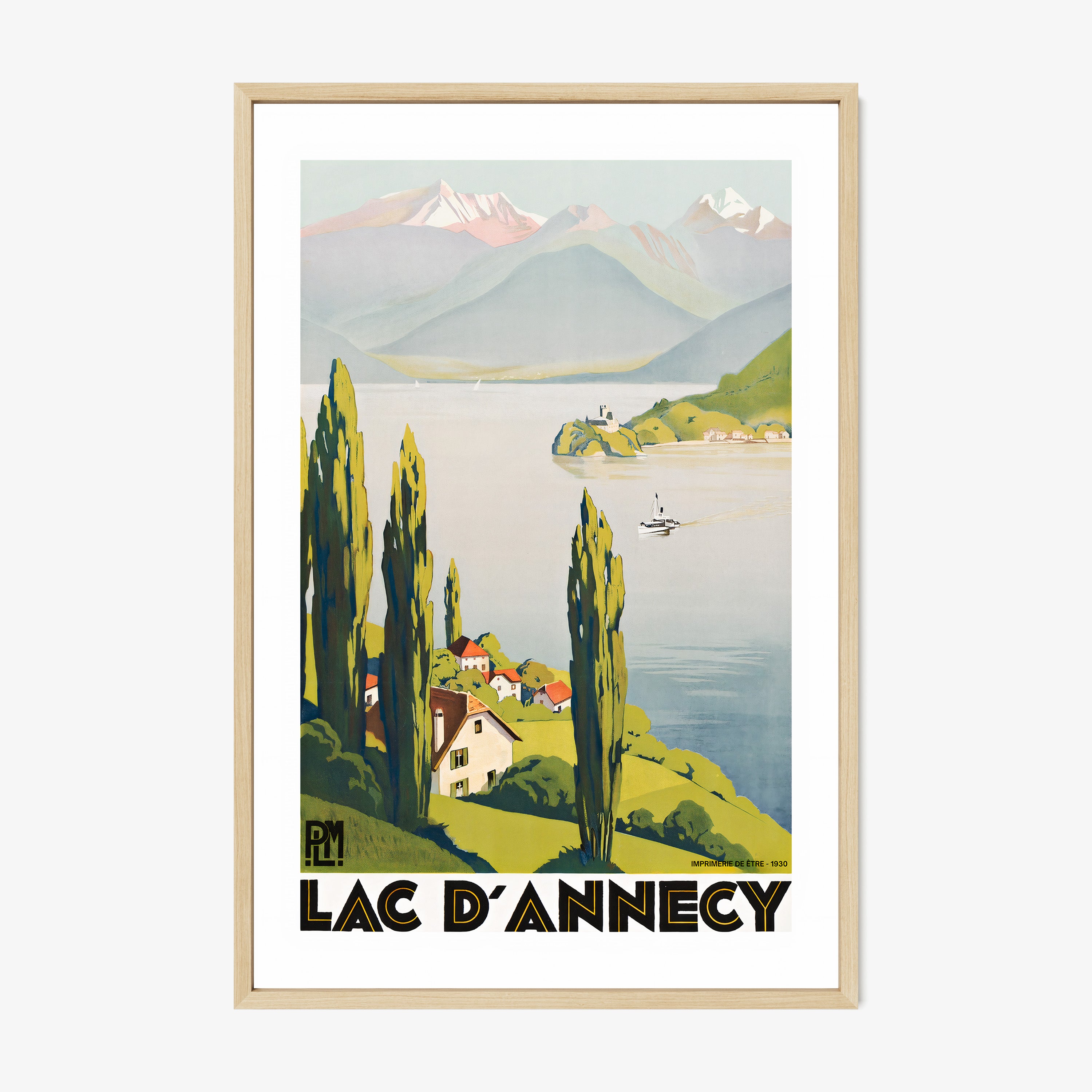 Framed "Lac D'Annecy" poster featuring a lake with a scenic mountain background hanging on a light background