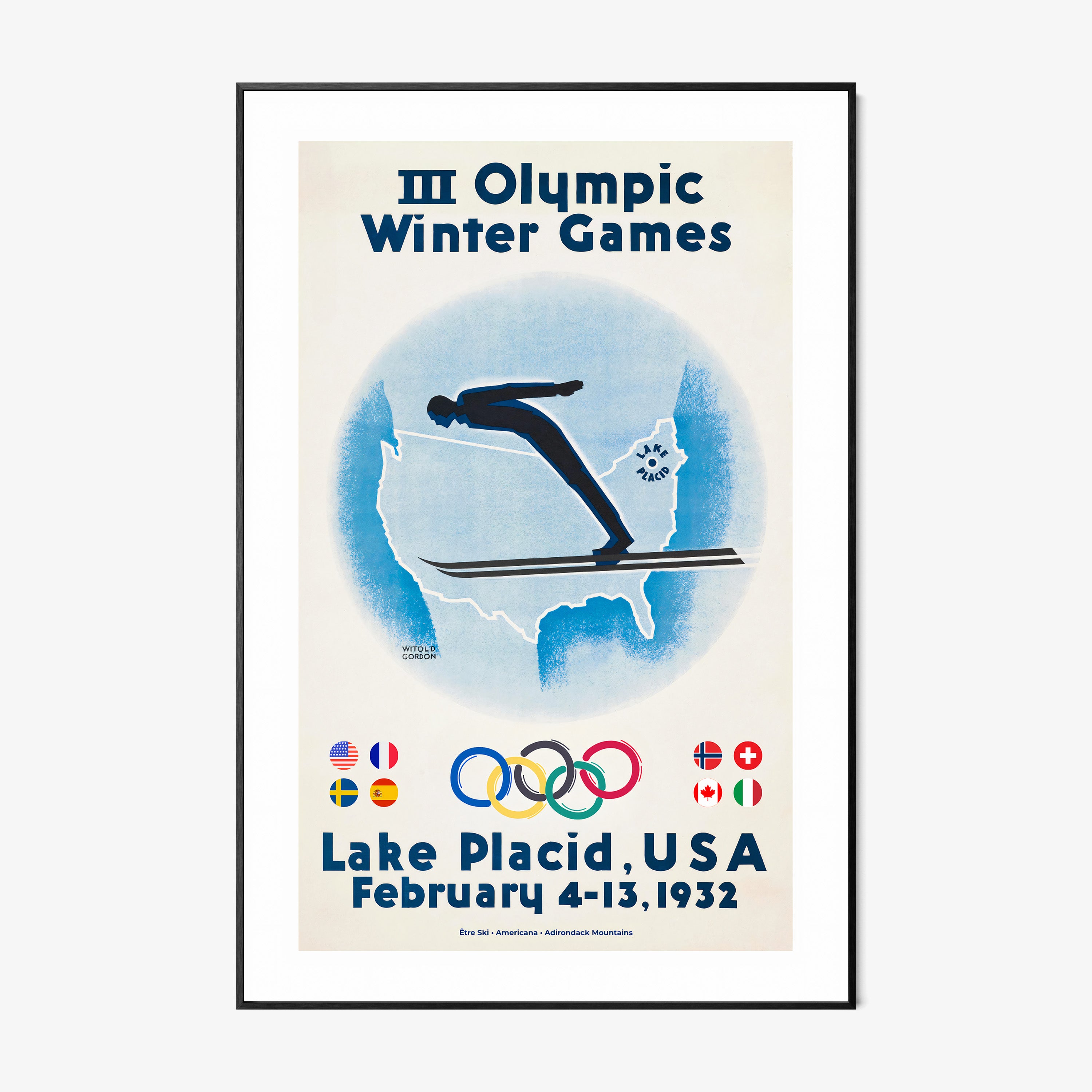 Framed poster of a skier with the United States map in the background and information on the 1932 Lake Placid winter olympic games hanging on a wall with a light background