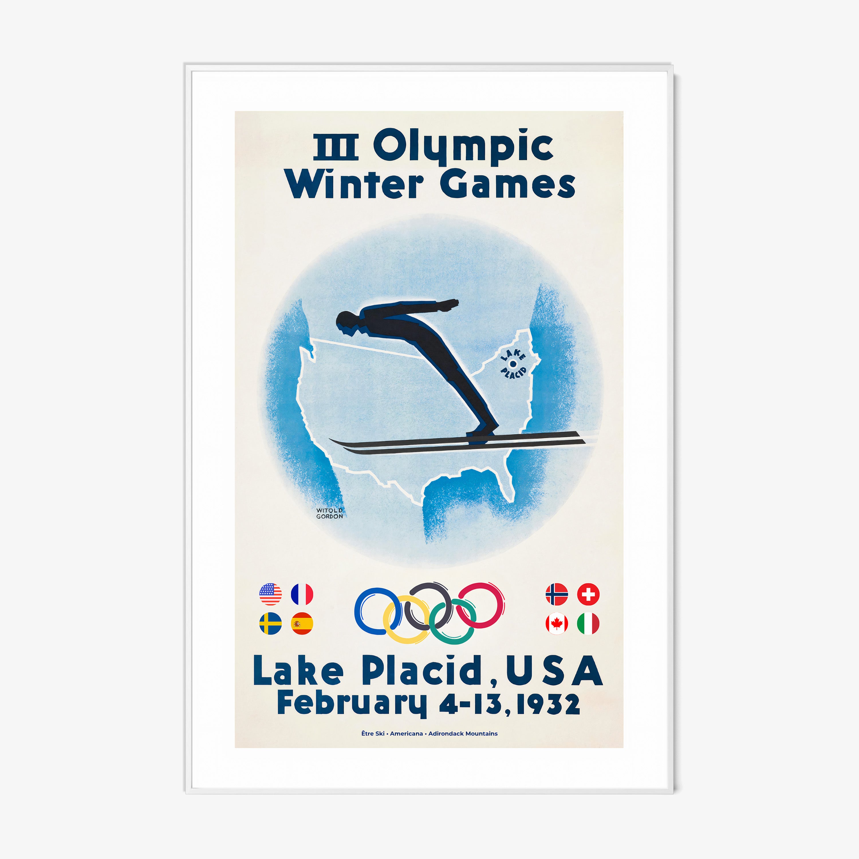 Framed poster of a skier with the United States map in the background and information on the 1932 Lake Placid winter olympic games hanging on a wall with a light background