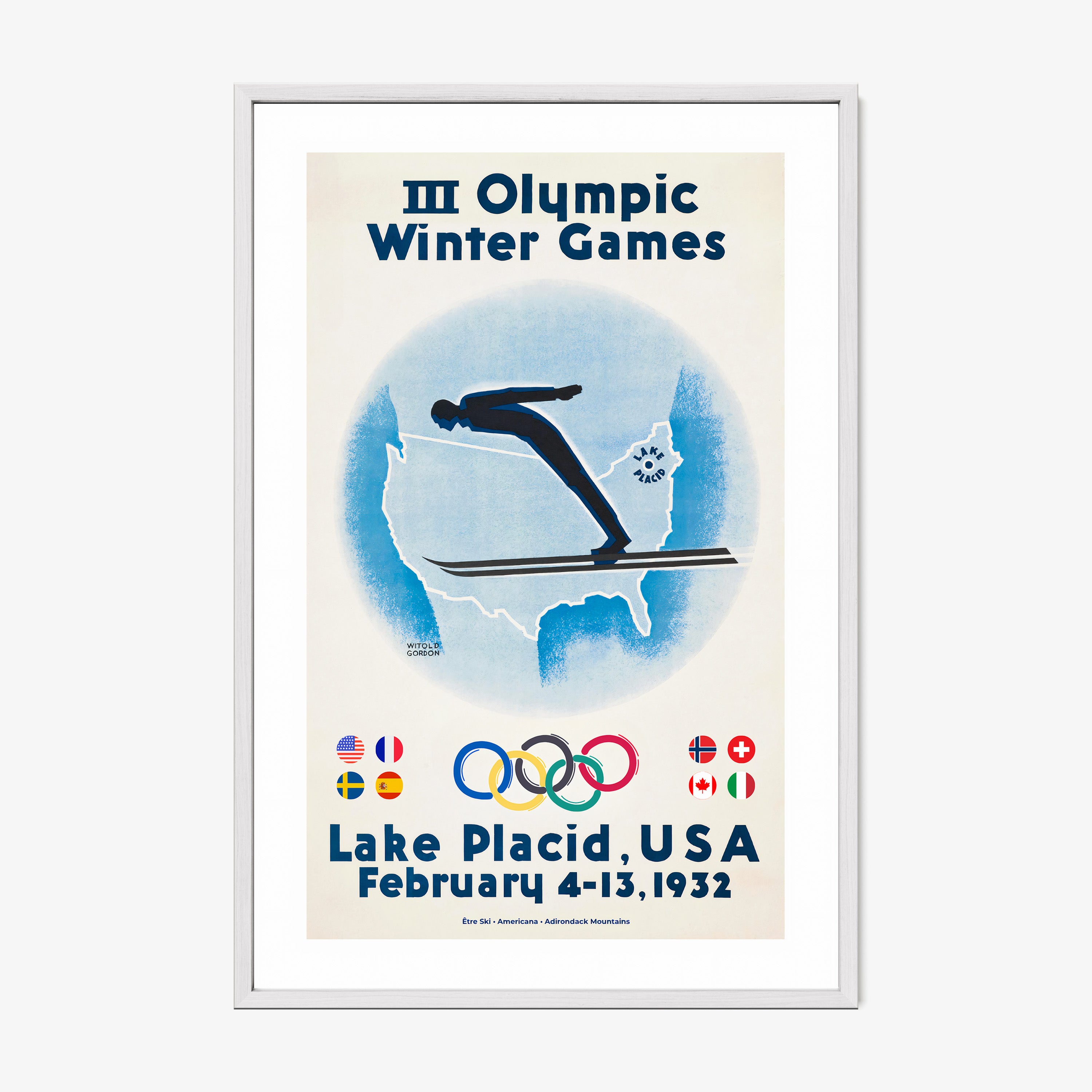 Framed poster of a skier with the United States map in the background and information on the 1932 Lake Placid winter olympic games hanging on a wall with a light background