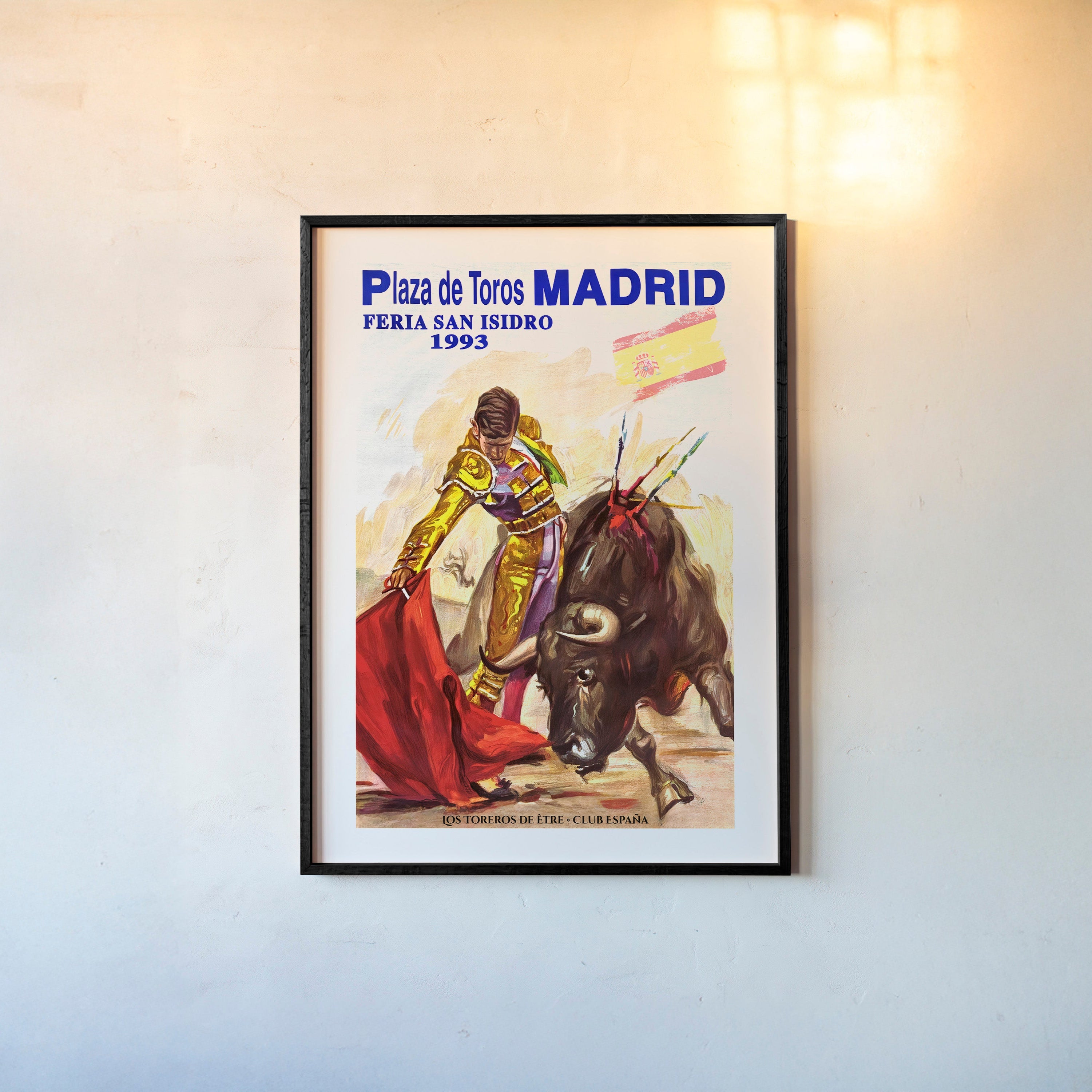 Framed poster of a bullfighter from Madrid hanging on a light background