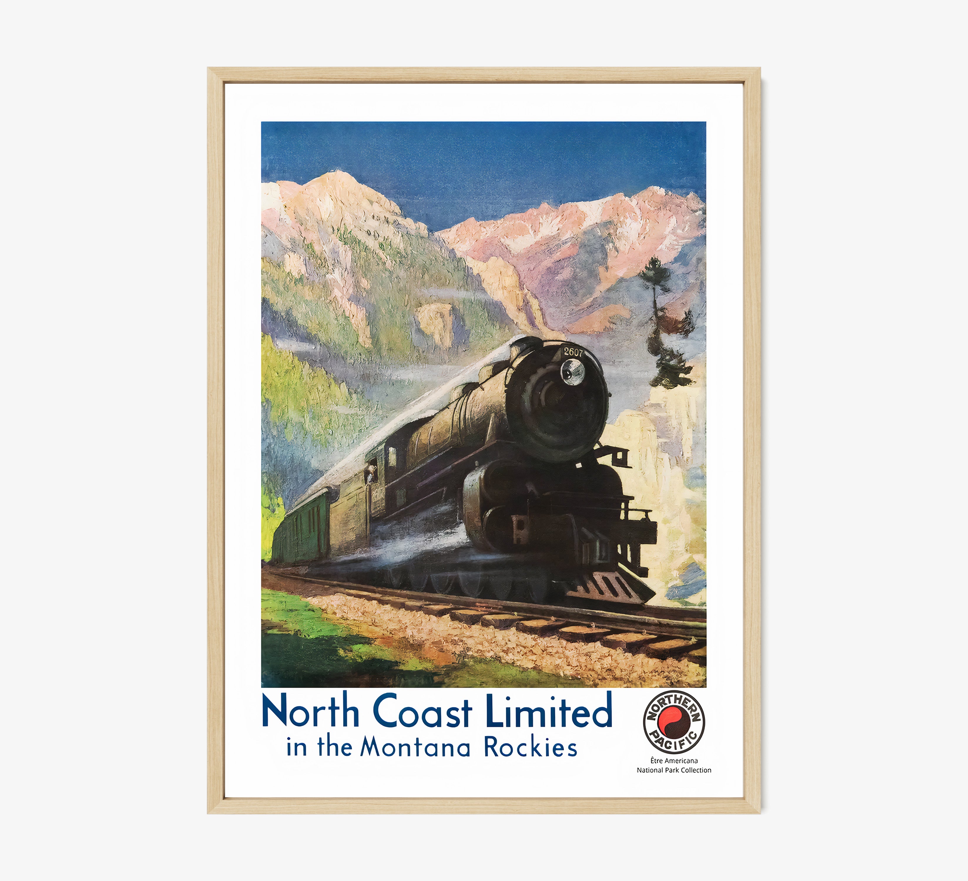 Framed poster of a train speeding through a mountain scene hanging on a light background