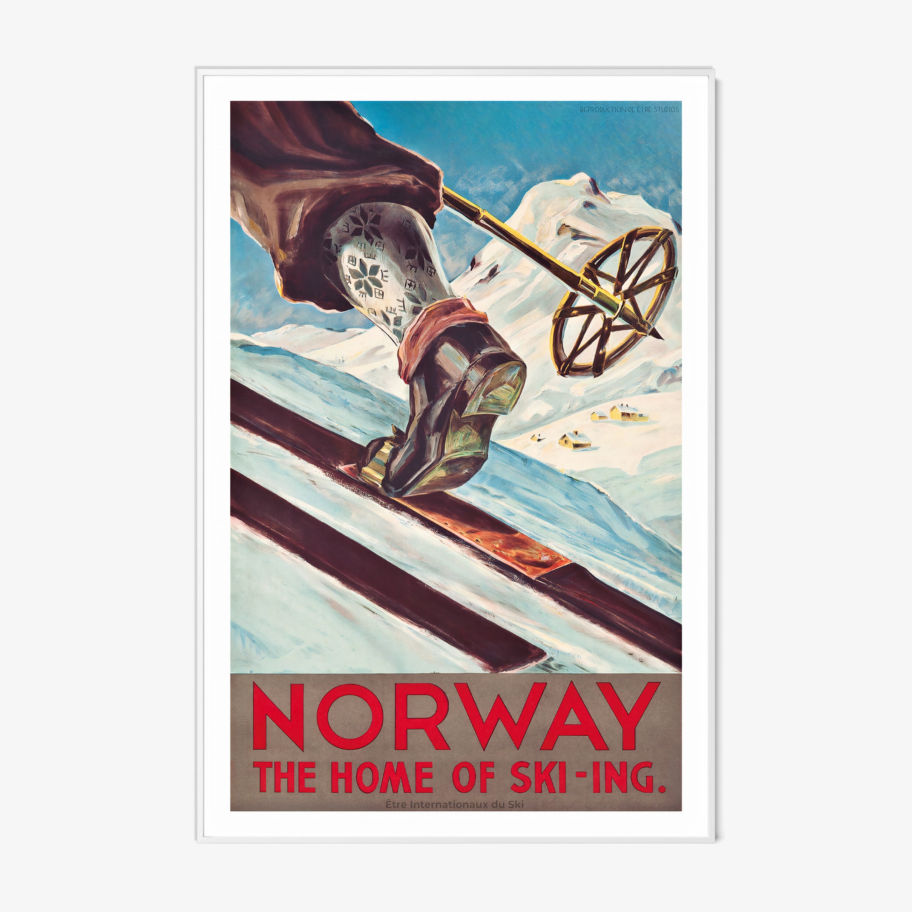 Framed poster featuring a close-up of a skier's leg and ski pole with patterned socks moving up a snowy hill with mountains in the background with the text "Norway, the home of ski-ing" at the bottom hanging on a white background