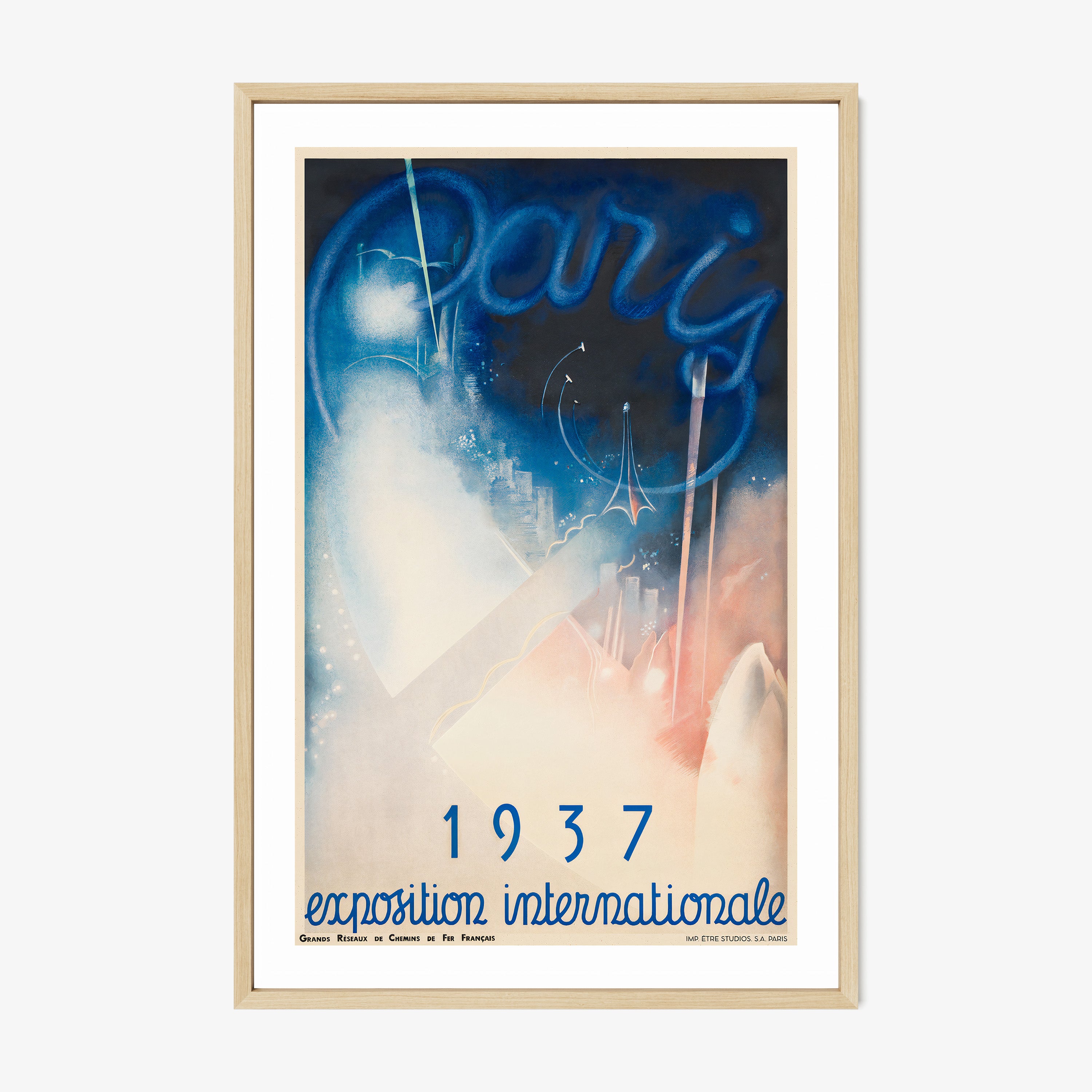 Framed poster of a whimsical blue and pink Paris scene with the text "1937 exposition internationale" at the bottom hanging on a light background
