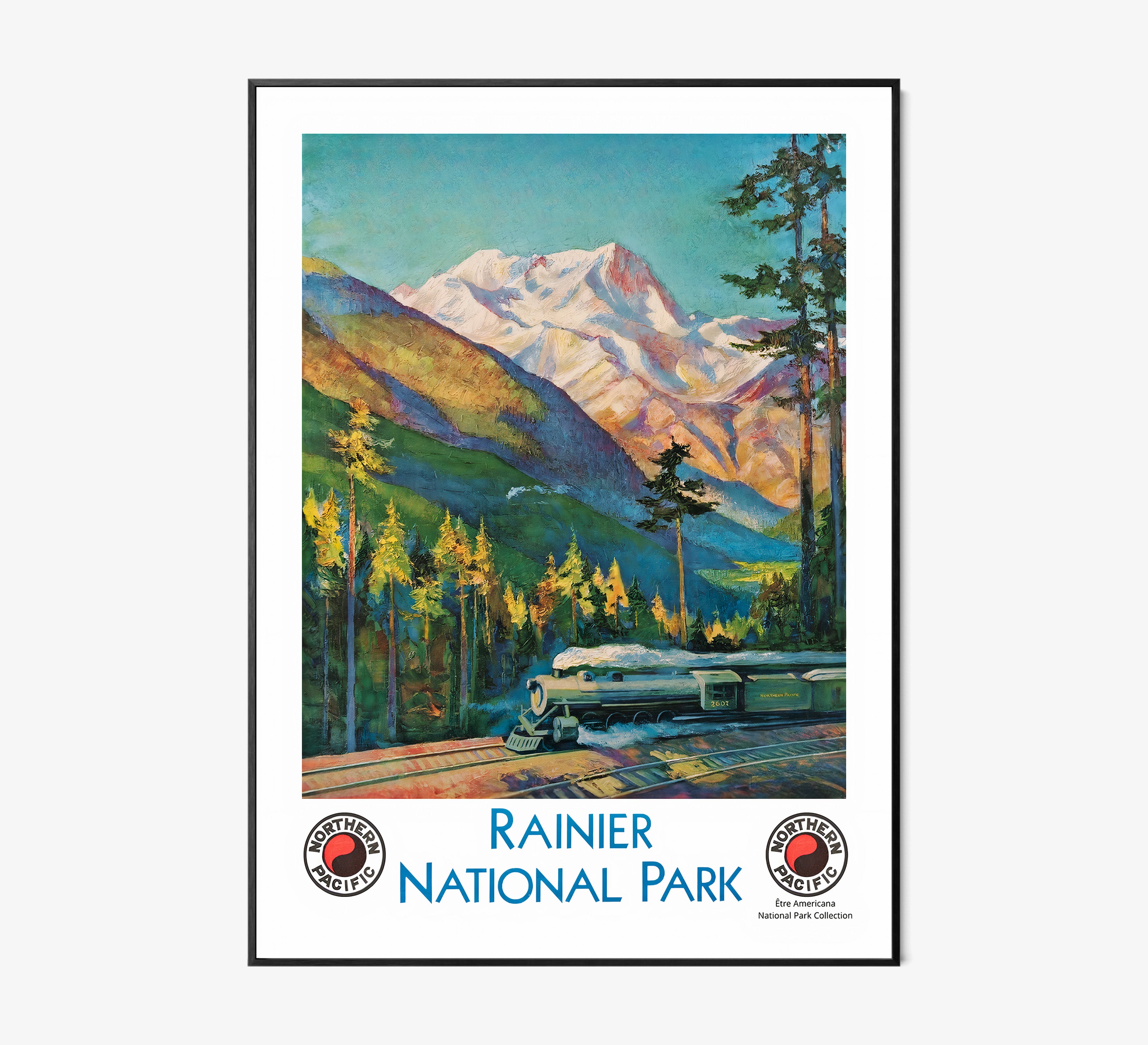 Framed "Rainier National Park" poster featuring a train and mountain scene hanging on a light background