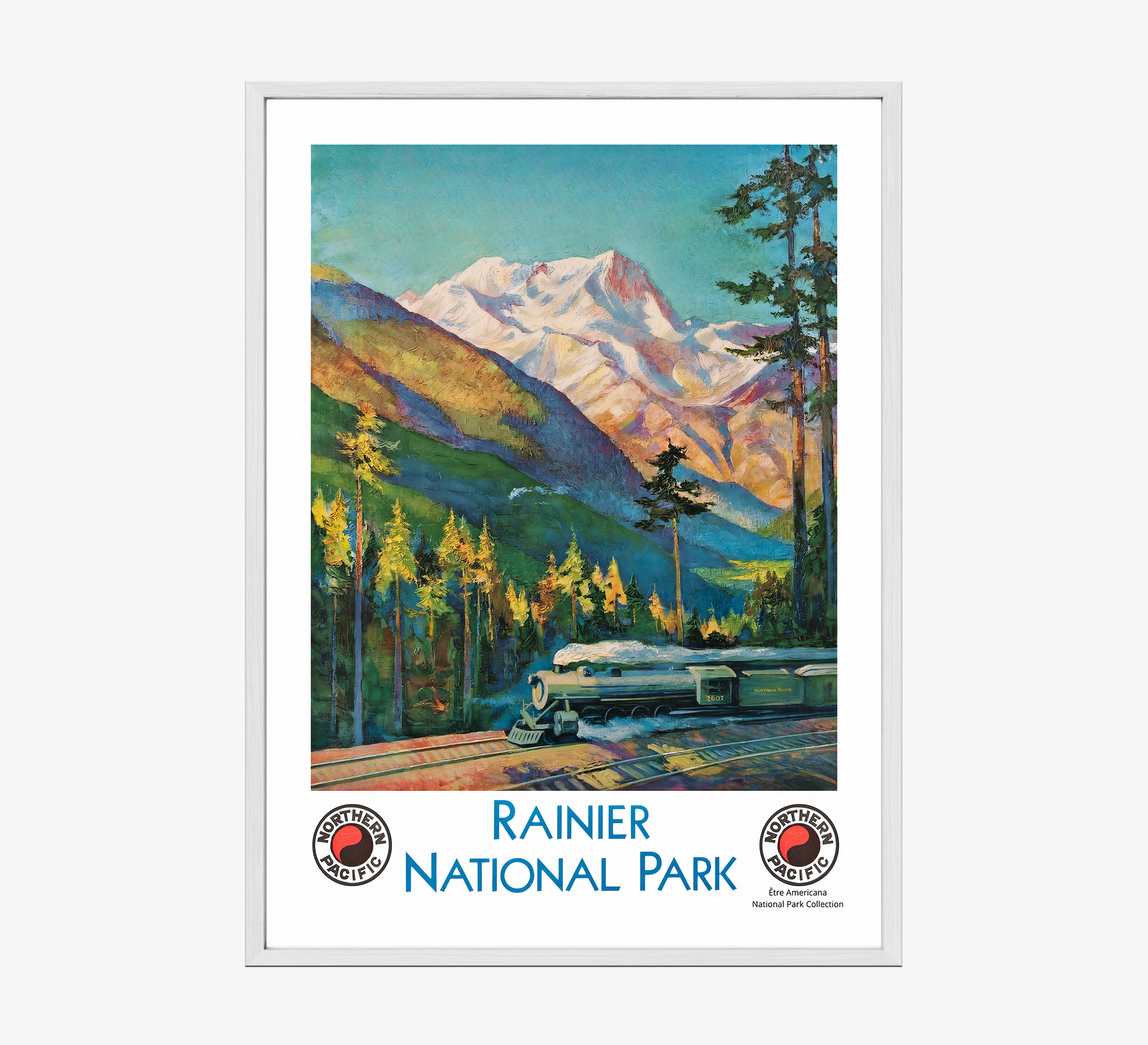Framed "Rainier National Park" poster featuring a train and mountain scene hanging on a light background