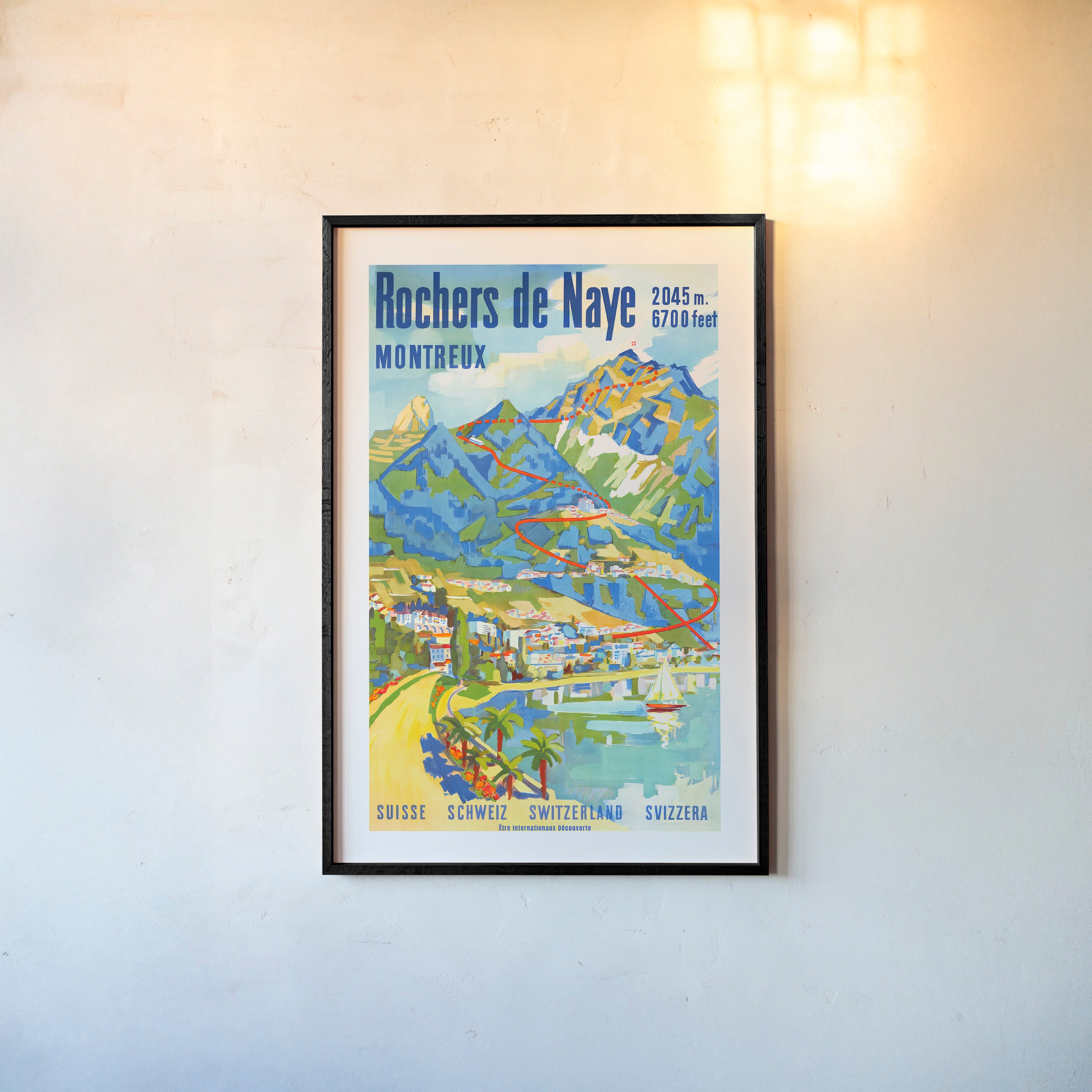 Framed Poster of "Rochers de Naye" a coastal mountain scene hanging on a light background