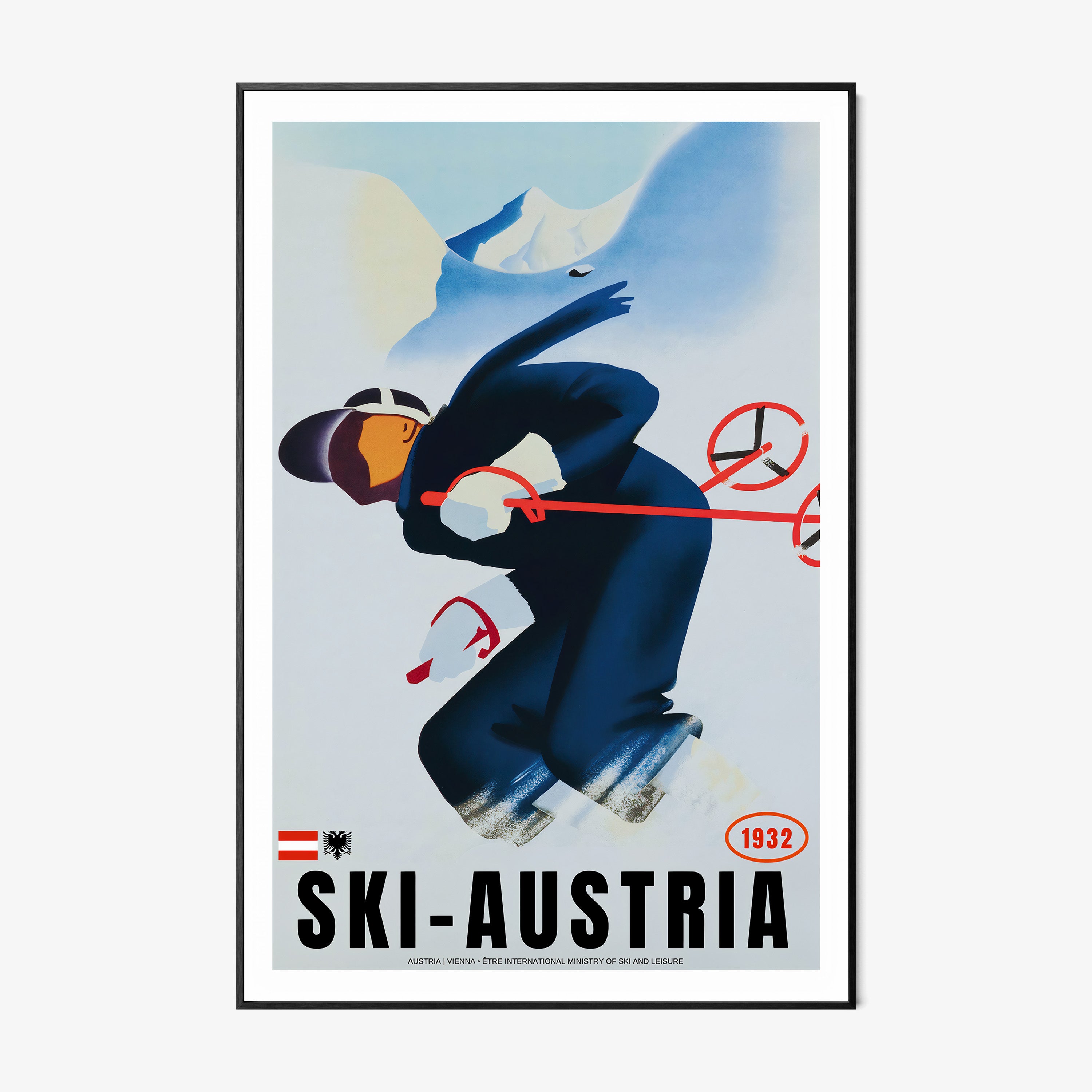 Framed poster of a skier with the text "Ski-Austria" at the bottom hanging on a light backdrop