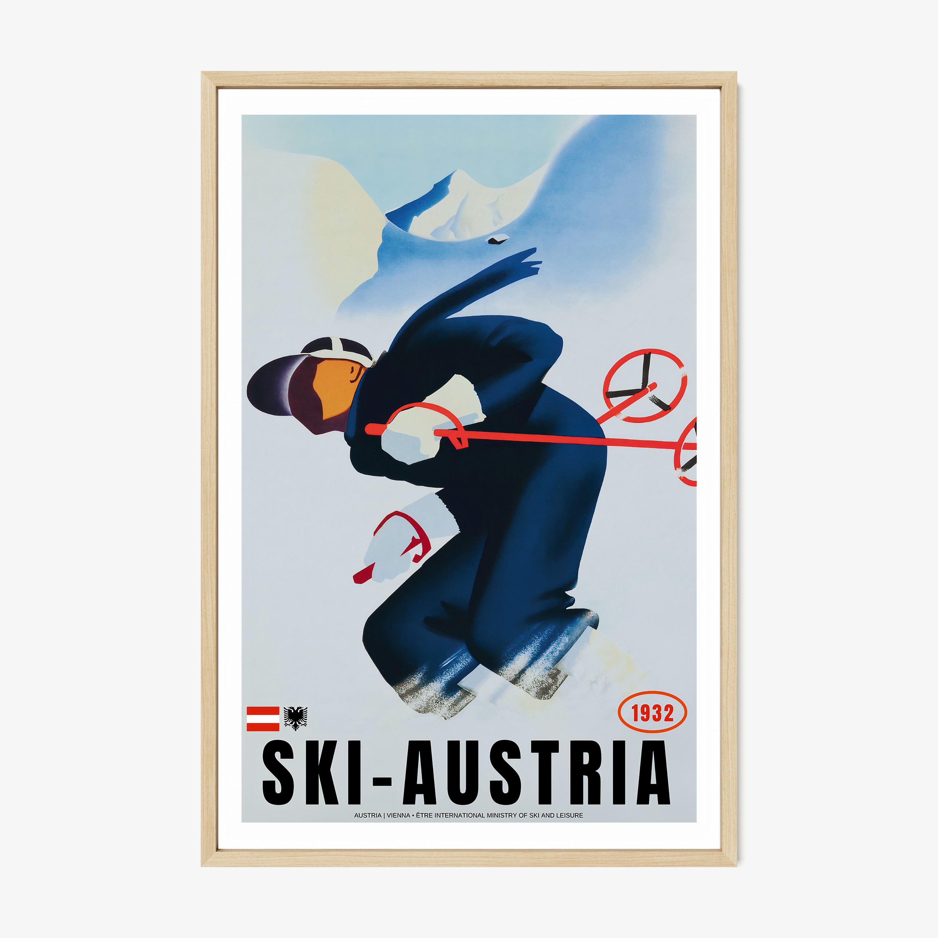 Framed poster of a skier with the text "Ski-Austria" at the bottom hanging on a light backdrop