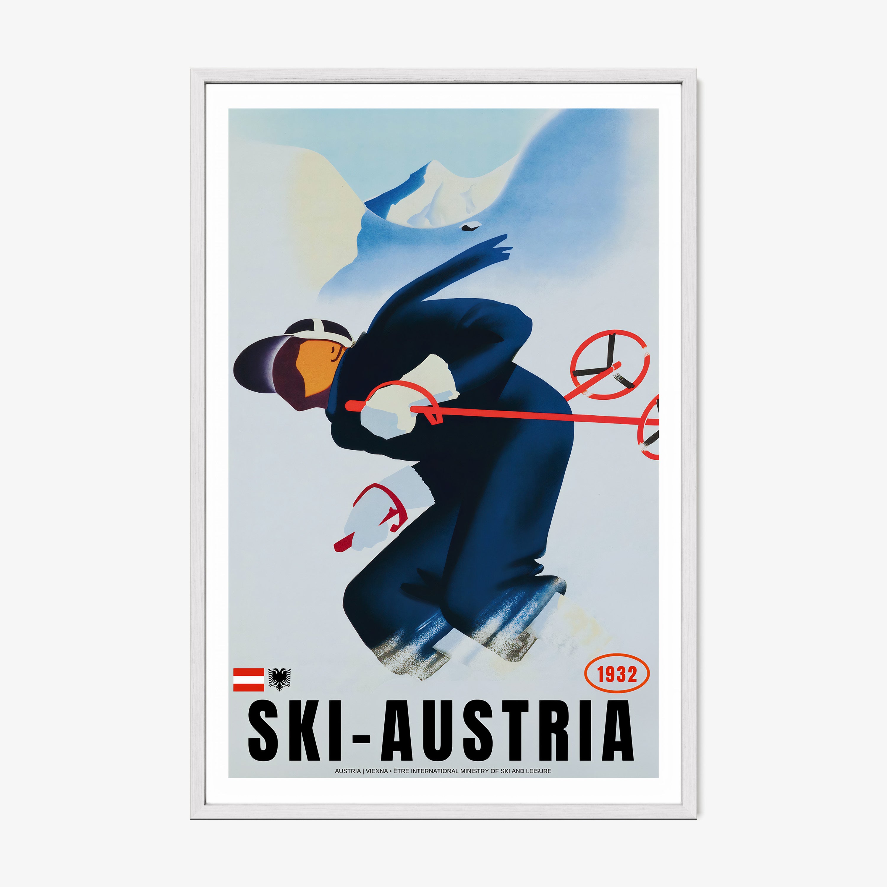 Framed poster of a skier with the text "Ski-Austria" at the bottom hanging on a light backdrop