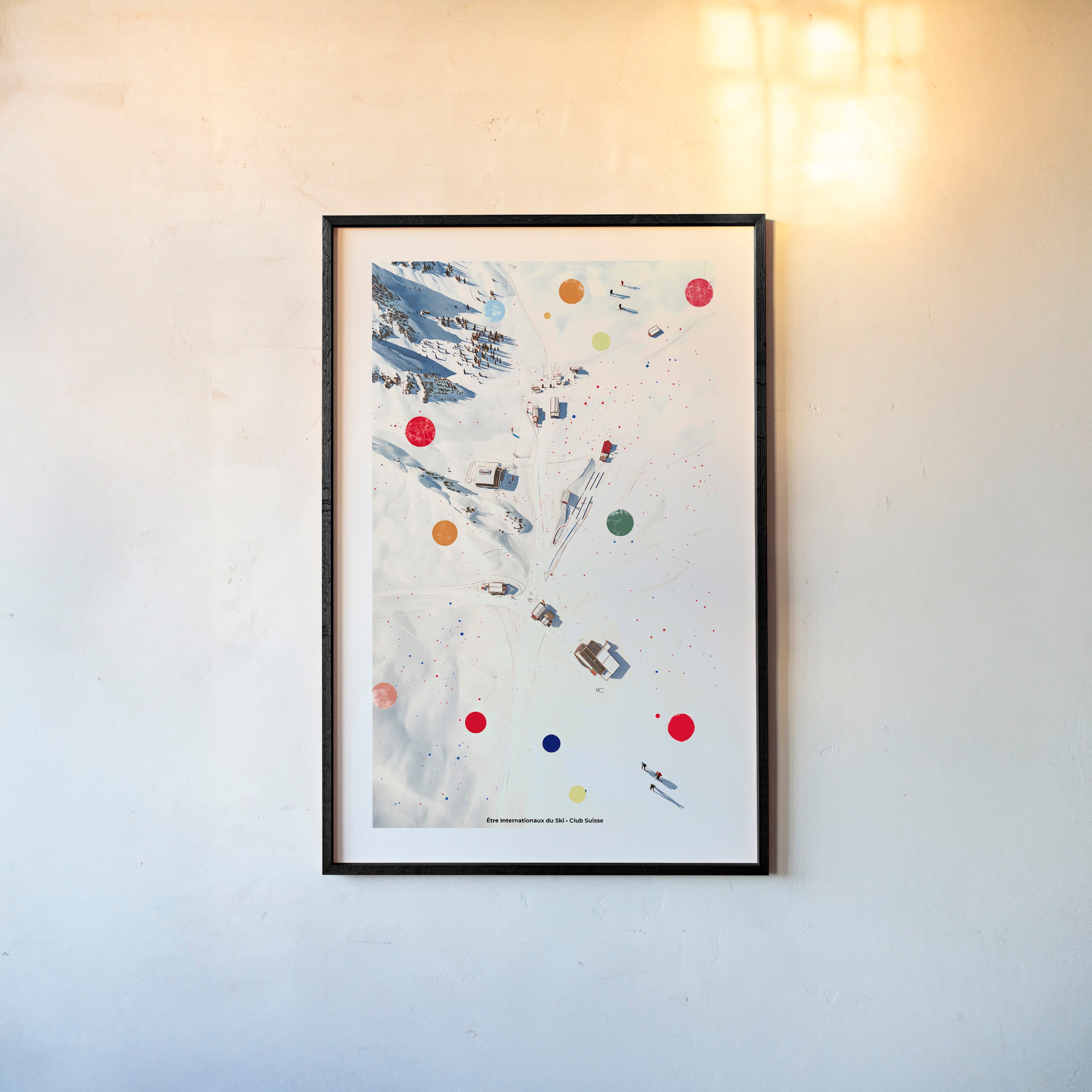 Framed poster of an overhead view of a snowy covered ski area hanging on a light background