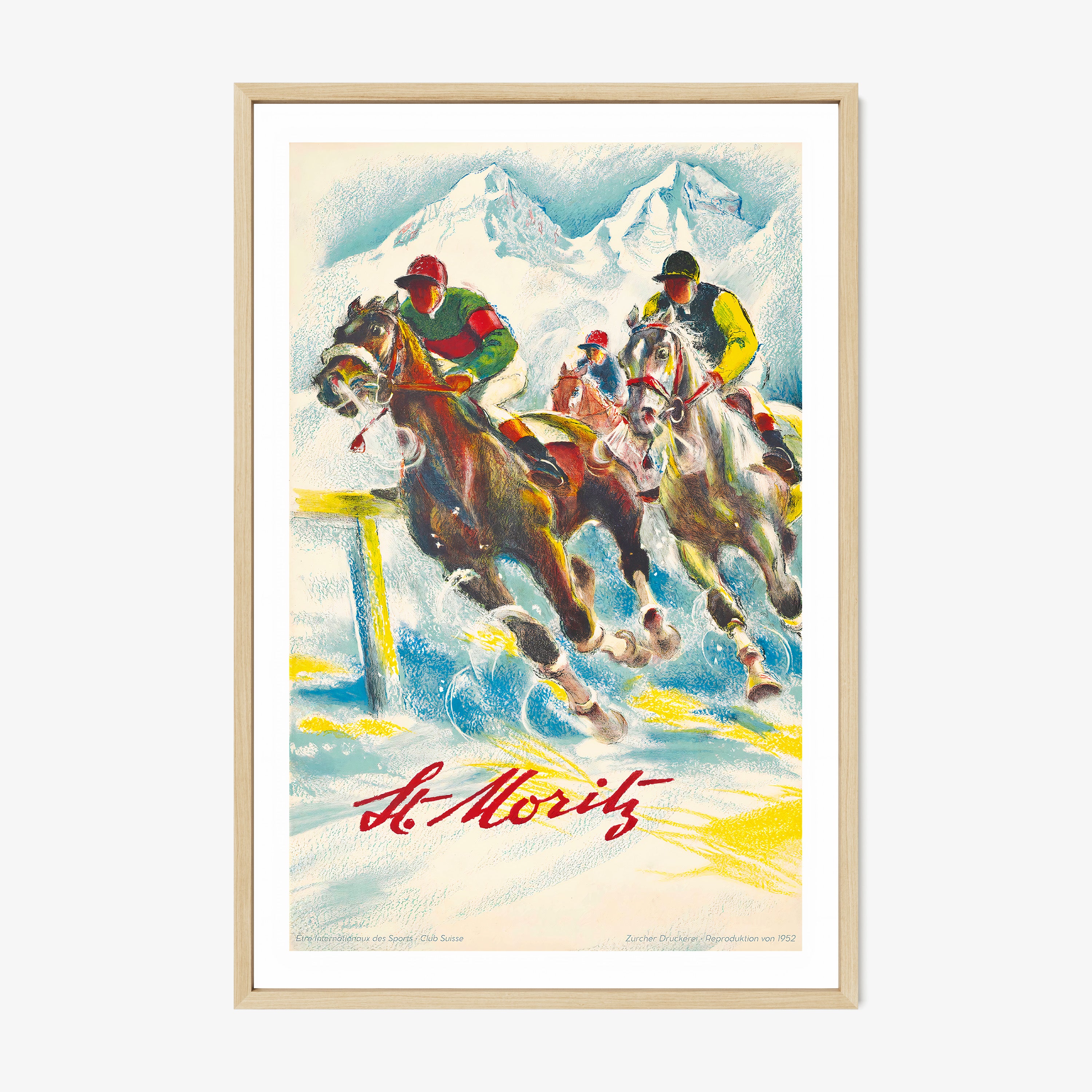 Framed poster of horse racers in the mountains with the text "St.Moritz" at the bottom hanging on a light background