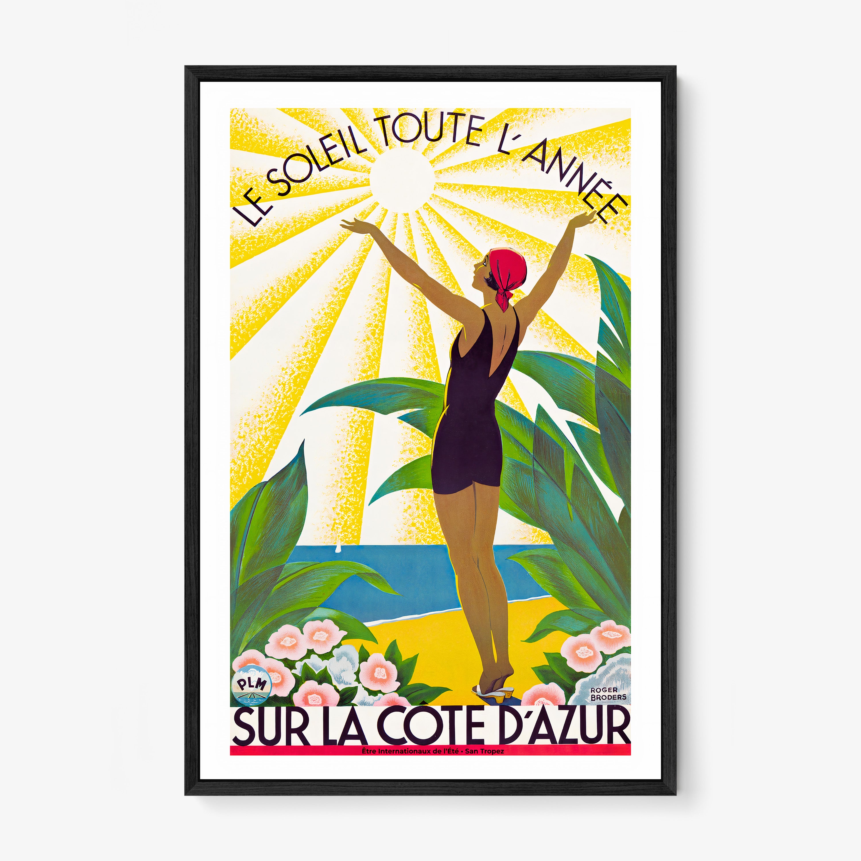 Framed poster of a woman standing with her arms raised to the sun and the text "Sur La Cote D'Azur" at the bottom hanging on a light background