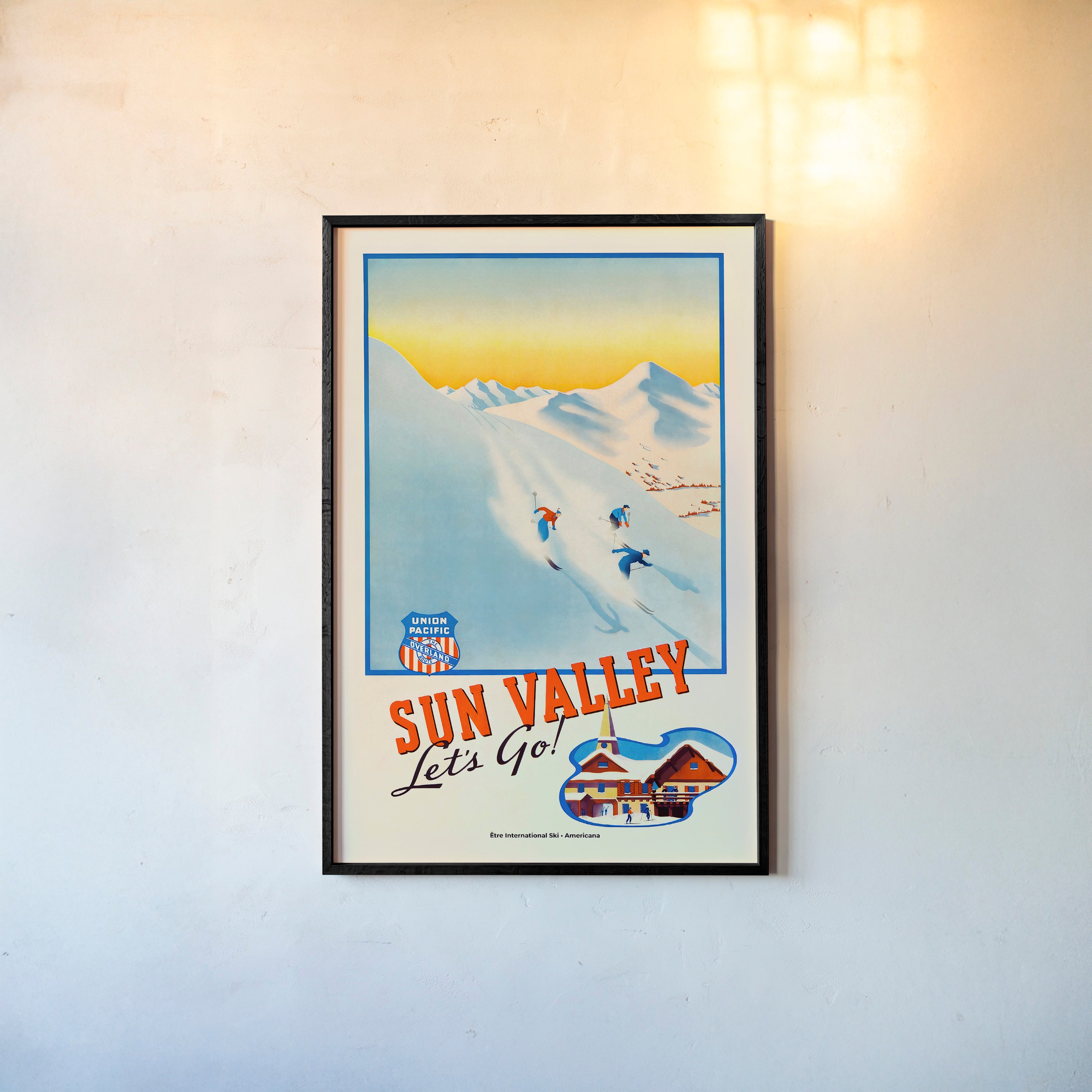 Framed "Sun Valley" poster featuring skier's going down a snowy mountain hanging on a light background