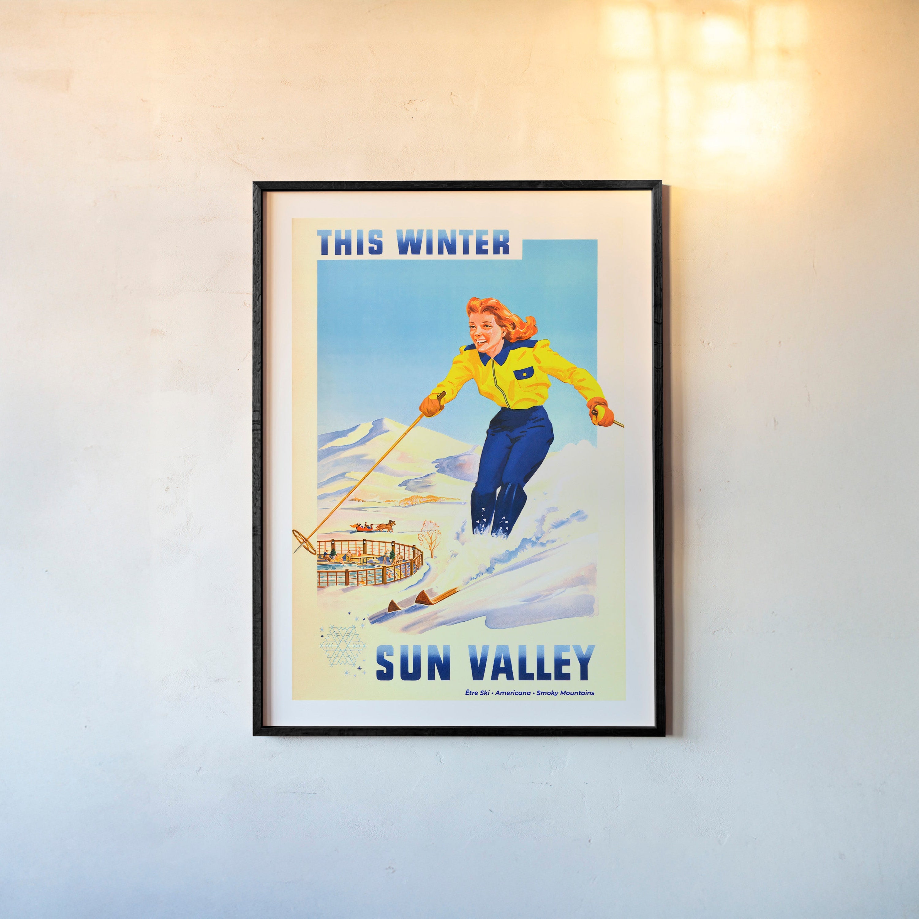 Framed "Sun Valley" poster featuring a woman skiing hanging on a light background
