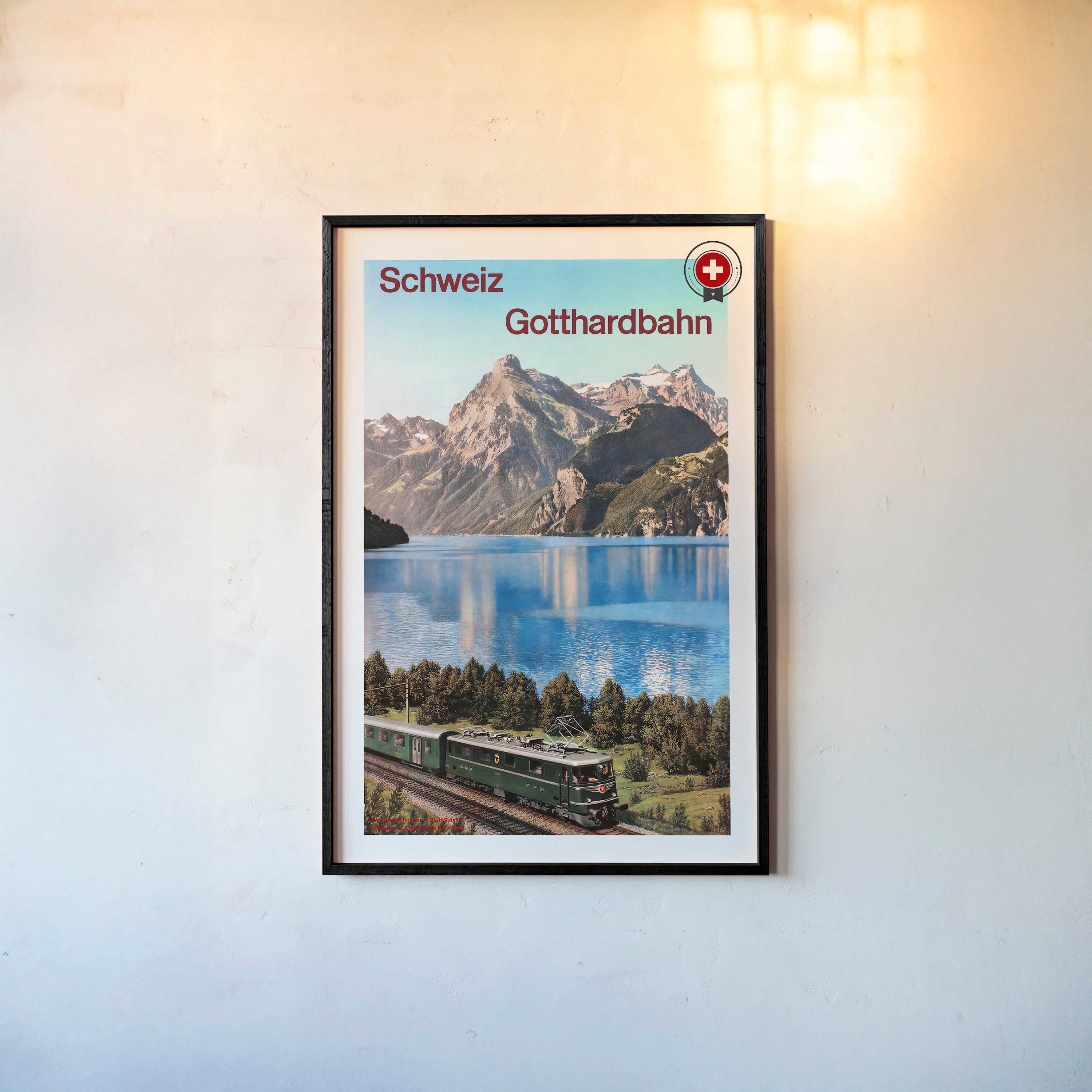 Framed poster of "Schweiz Gotthardbahn" featuring a train next to a mountain lake scene