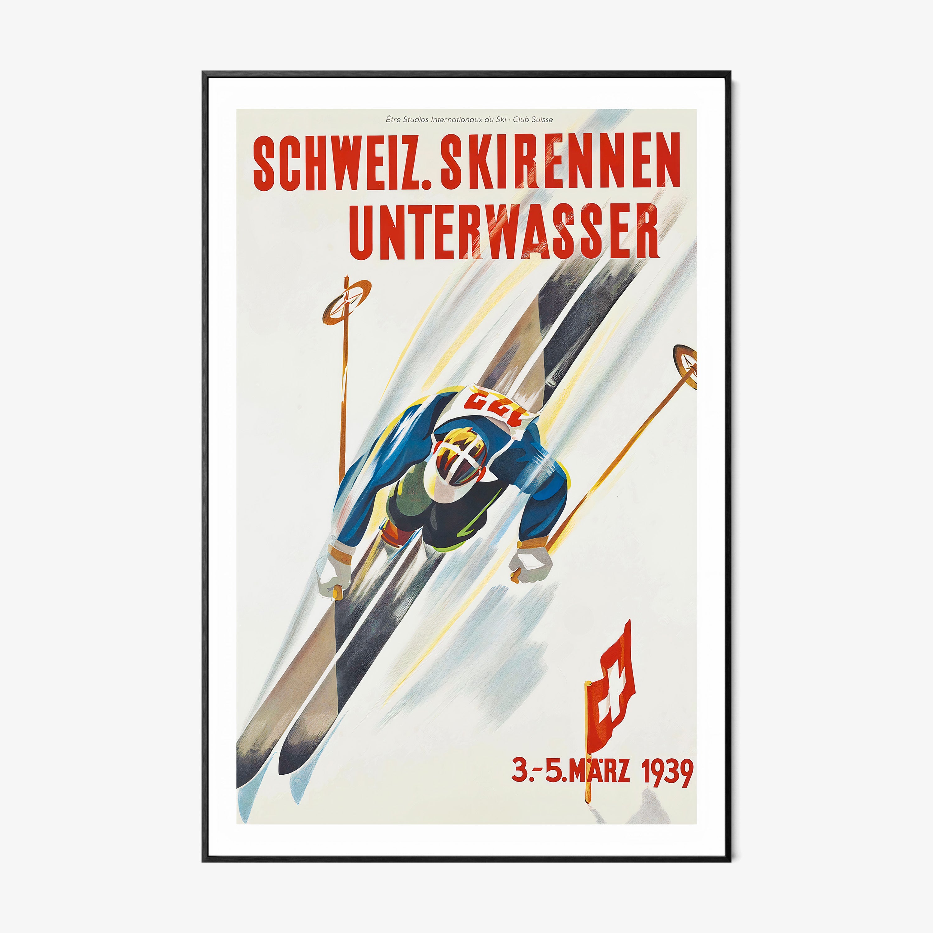 Framed poster of a skier taken from above hanging on a light backdrop