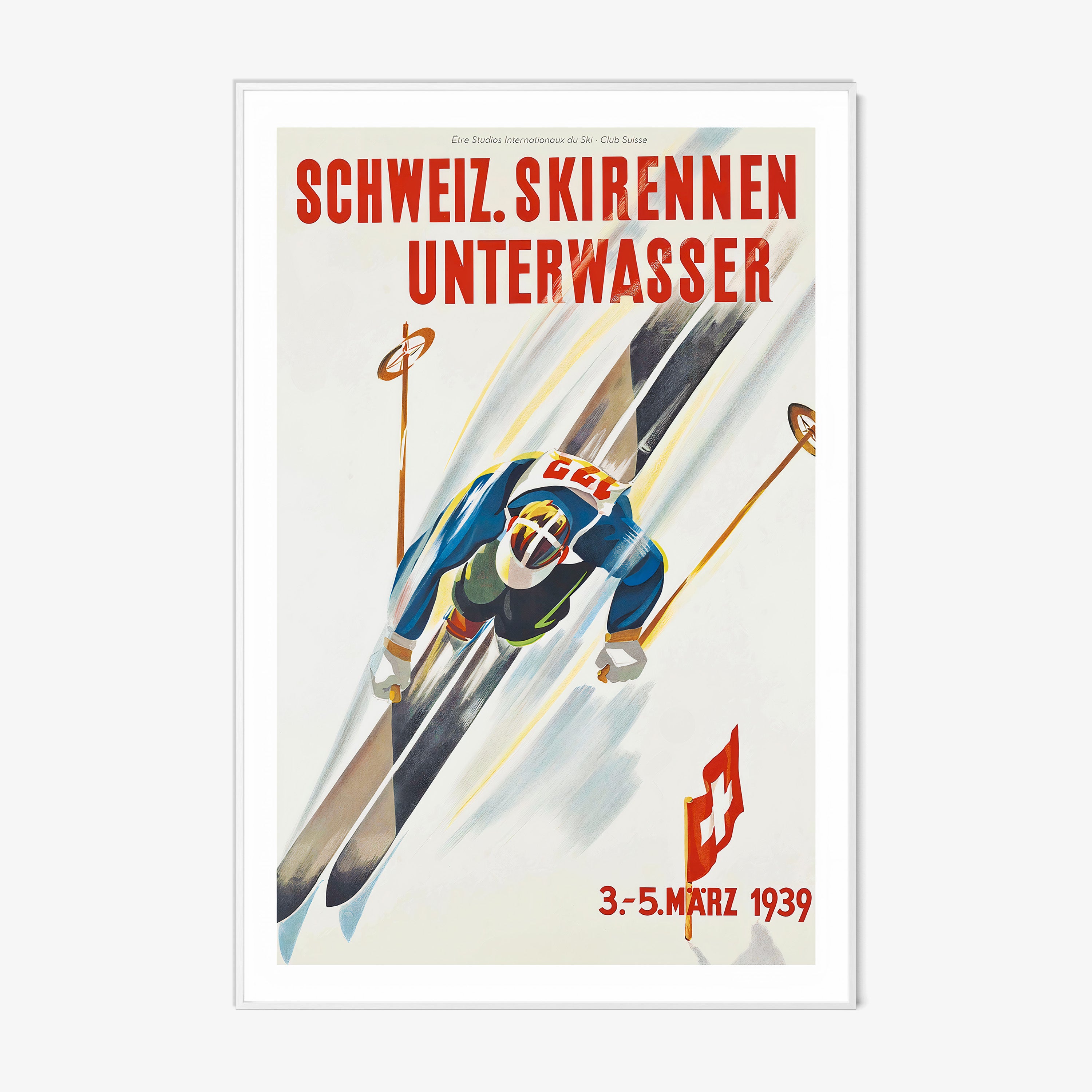 Framed poster of a skier taken from above hanging on a light backdrop