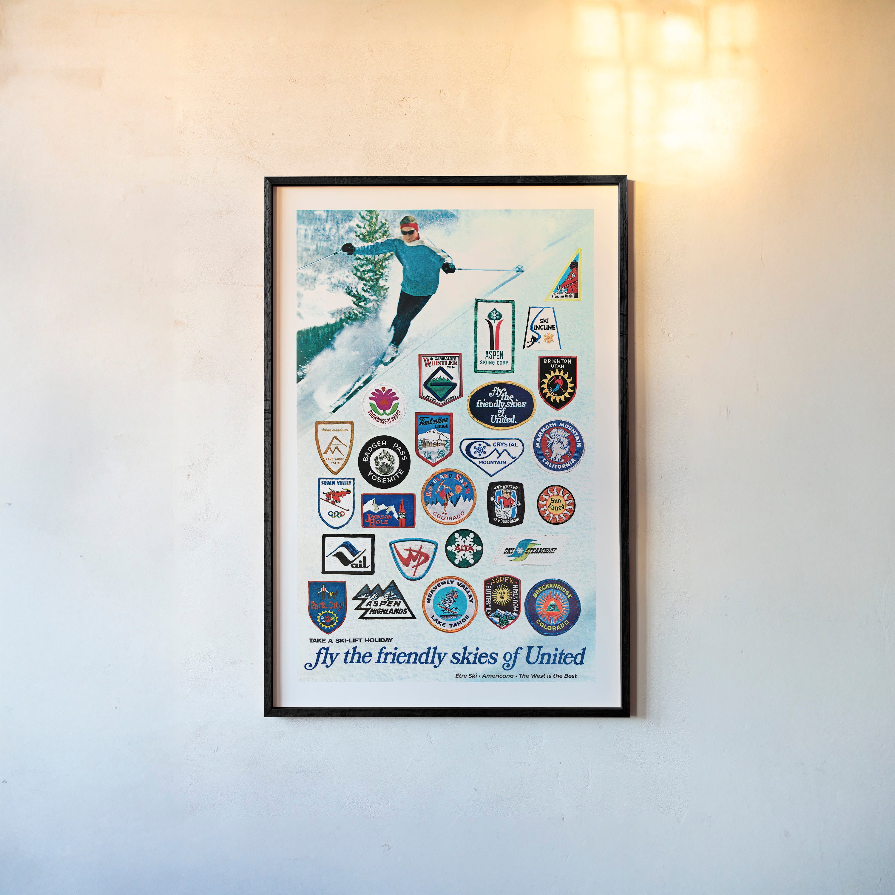 Vintage style framed poster of ski areas in the United States hanging on a light background