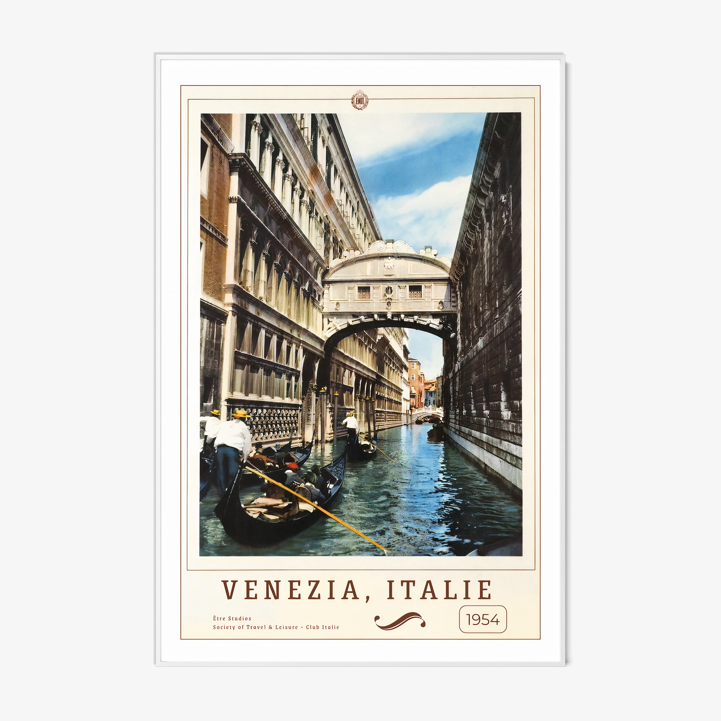 Framed poster of people on boats in a canal in between buildings with the text "Venezia, Italie" in large hanging on a wall with a light background