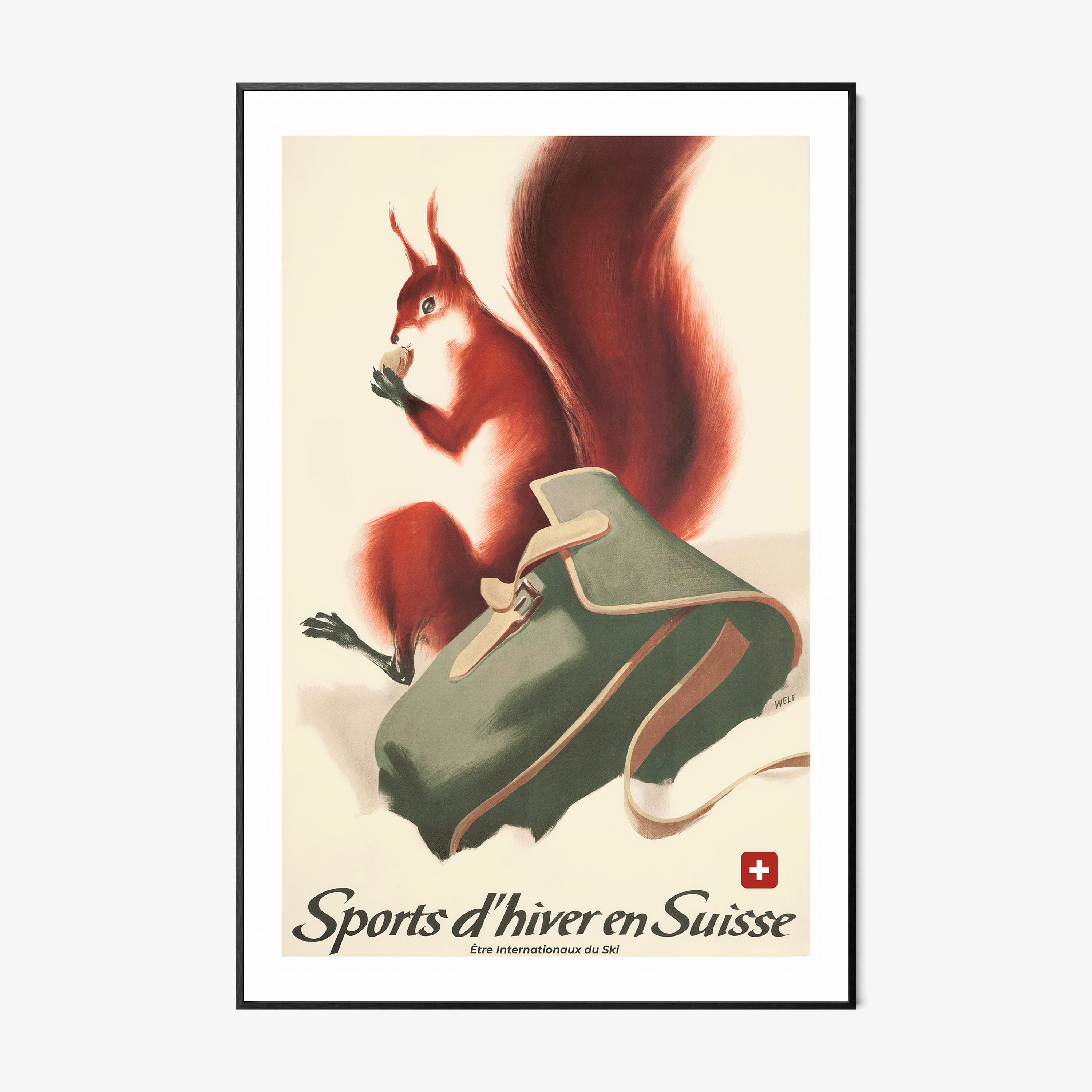 Framed poster of a fox next to a backpack in the snow with the text "Sports d'hiver en Suisse" at the bottom hanging on a wall with a light backdrop