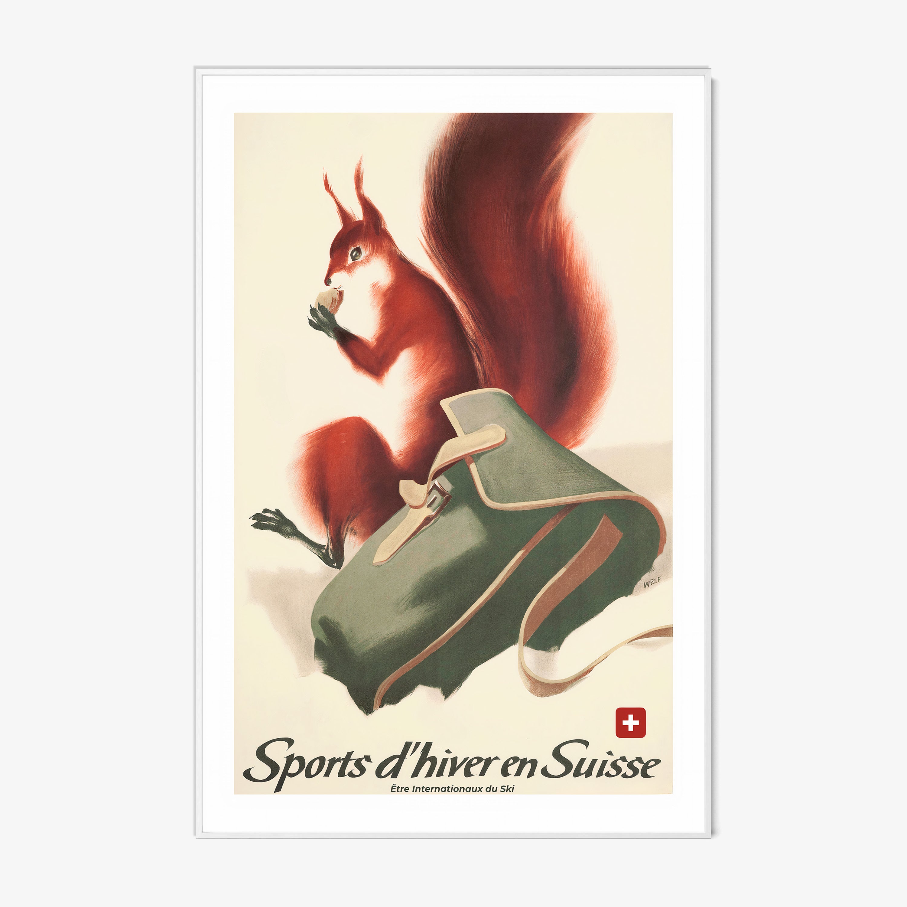 Framed poster of a fox next to a backpack in the snow with the text "Sports d'hiver en Suisse" at the bottom hanging on a wall with a light backdrop