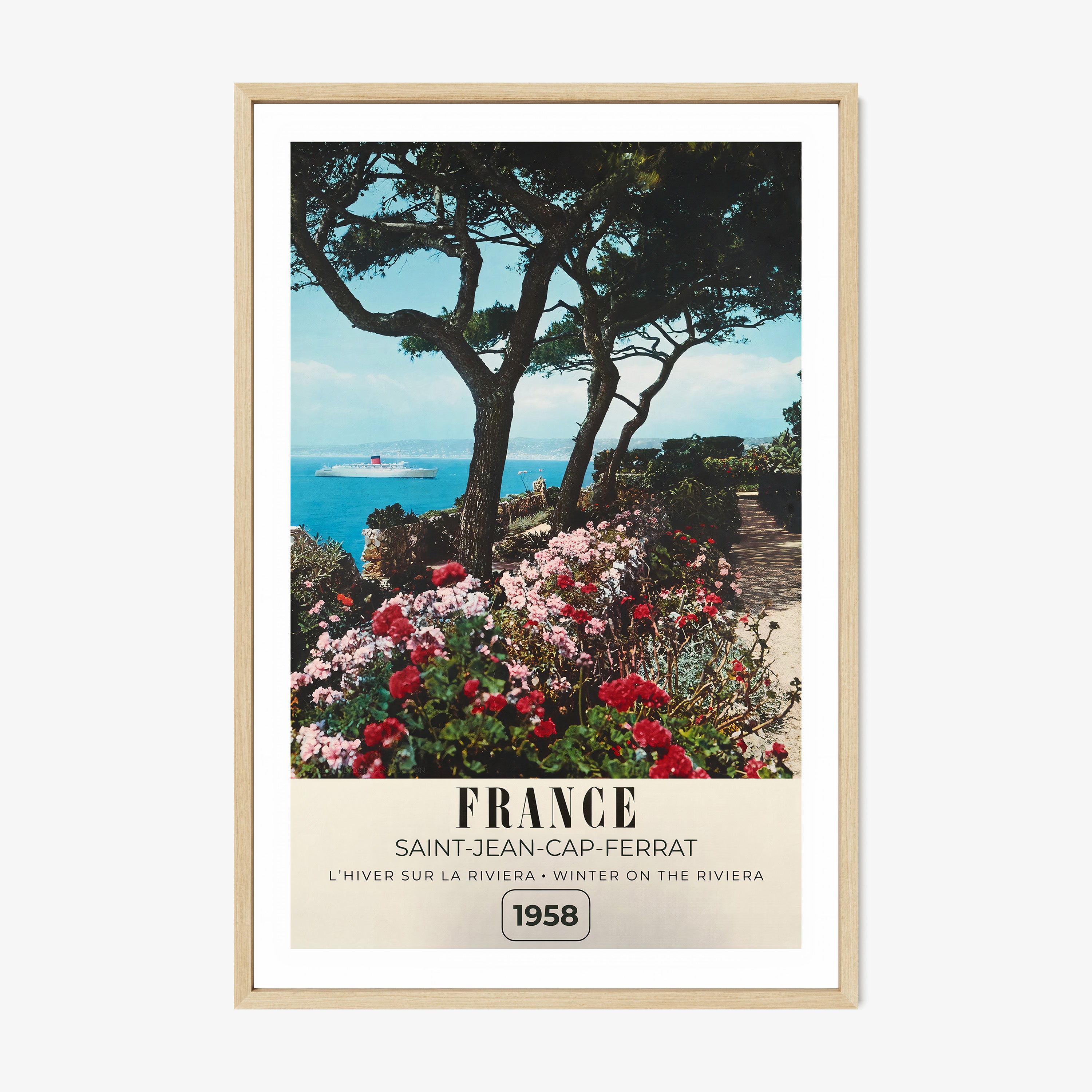 Framed poster of a river with flowers blooming around it and the text "France" in large letters, hanging on a wall with a light background