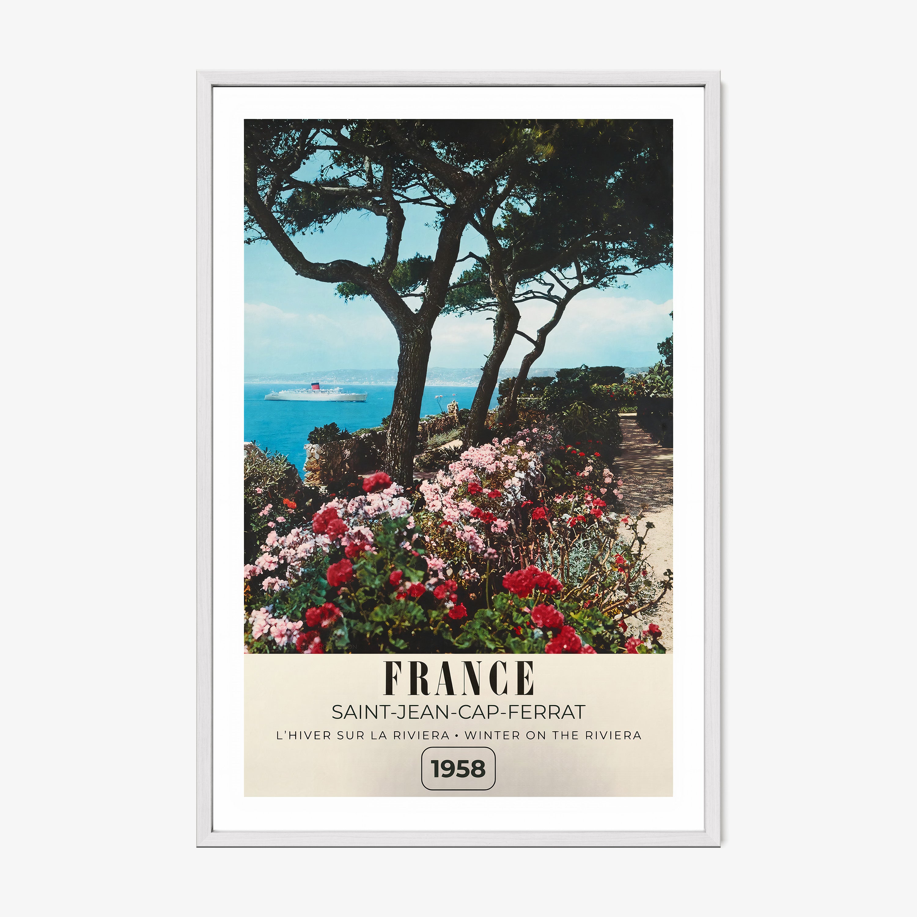 Framed poster of a river with flowers blooming around it and the text "France" in large letters, hanging on a wall with a light background