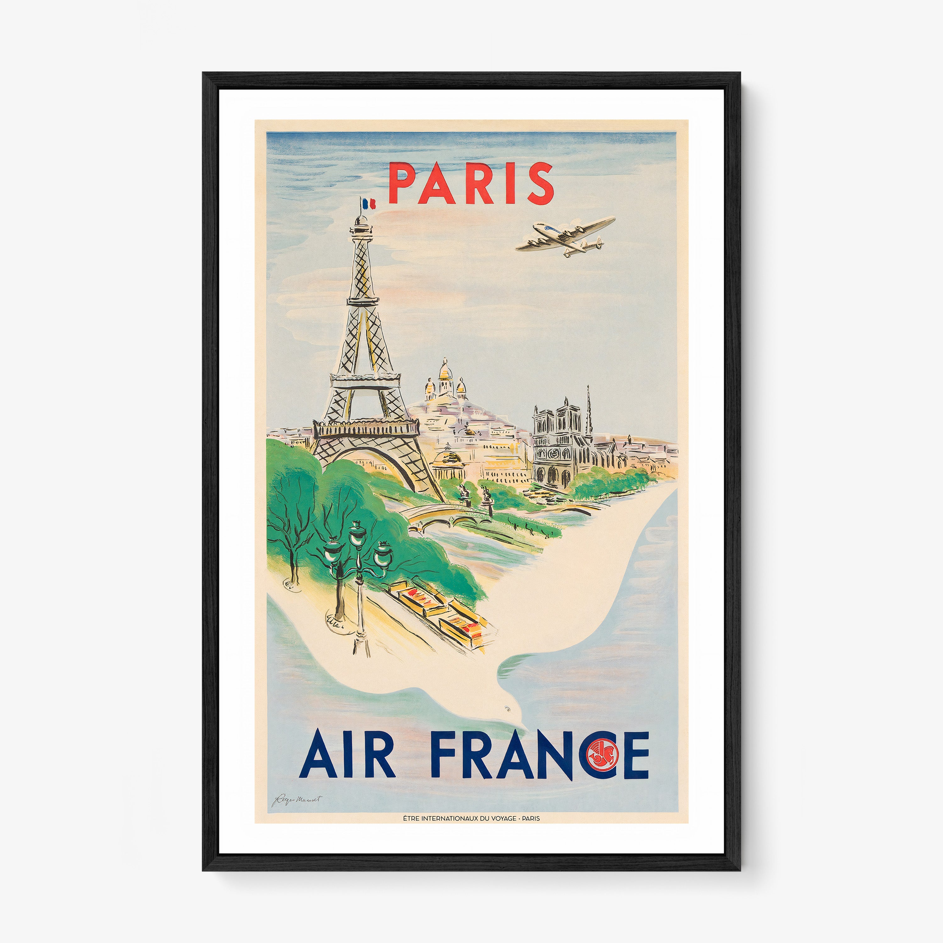 Framed Air France poster of Paris on a wall