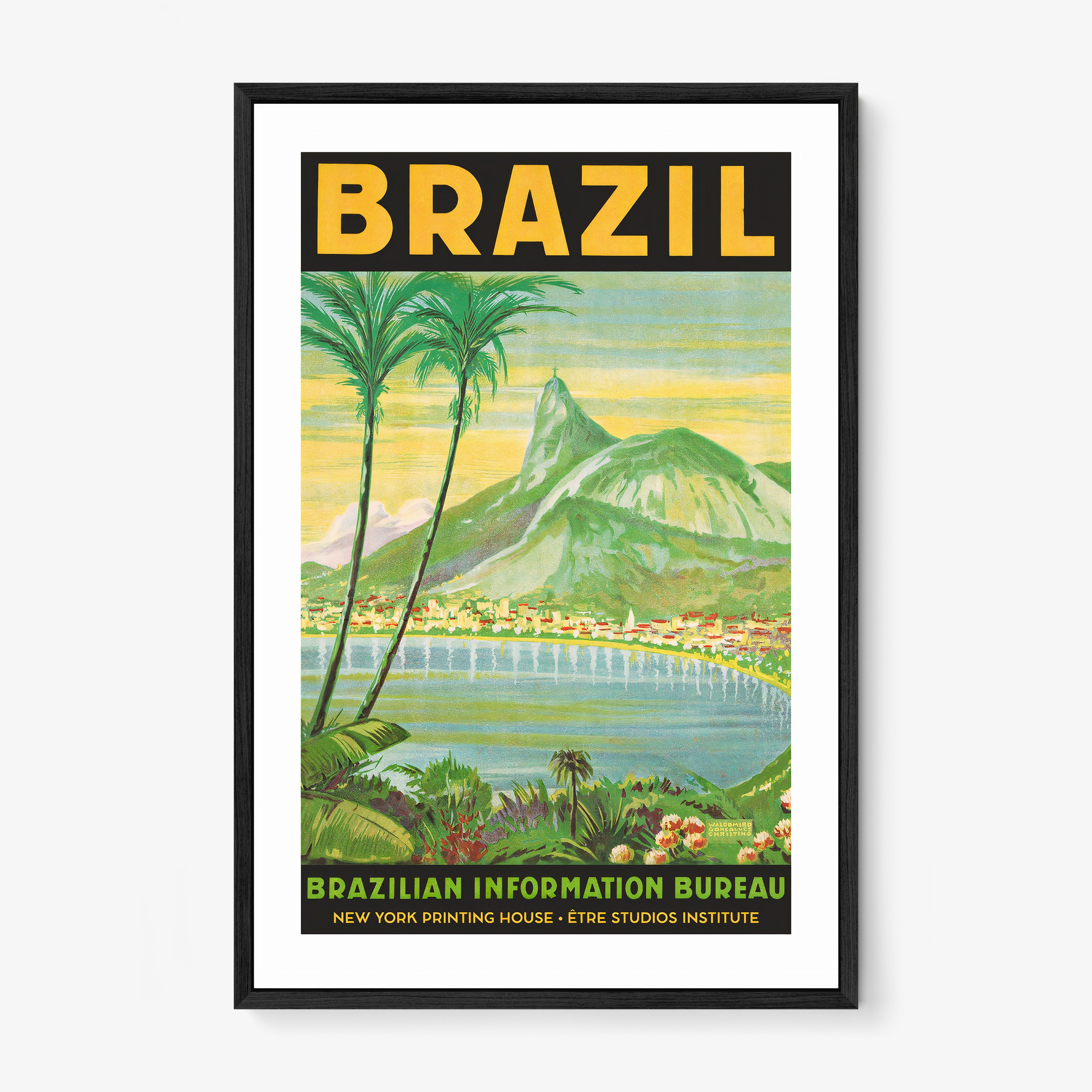 Framed poster of a waterfront with mountains in the background and the words "Brazil" in large letters at the top sitting on a light background